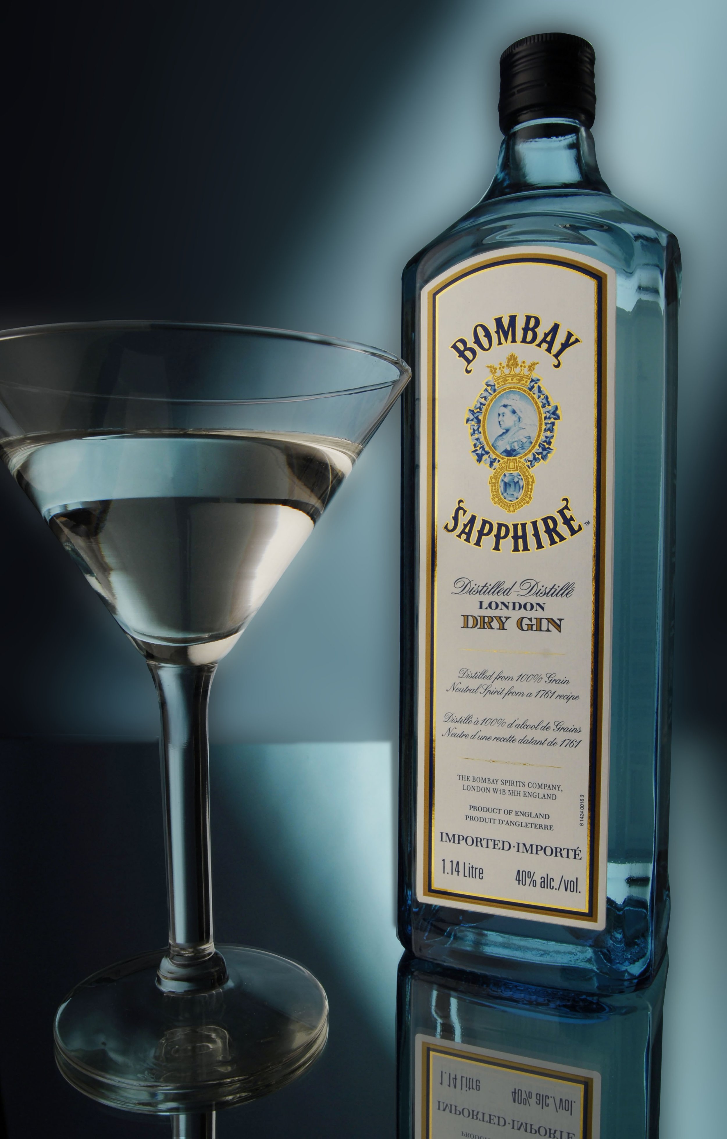 Bottle of Bombay Sapphire gin beside a martini glass.