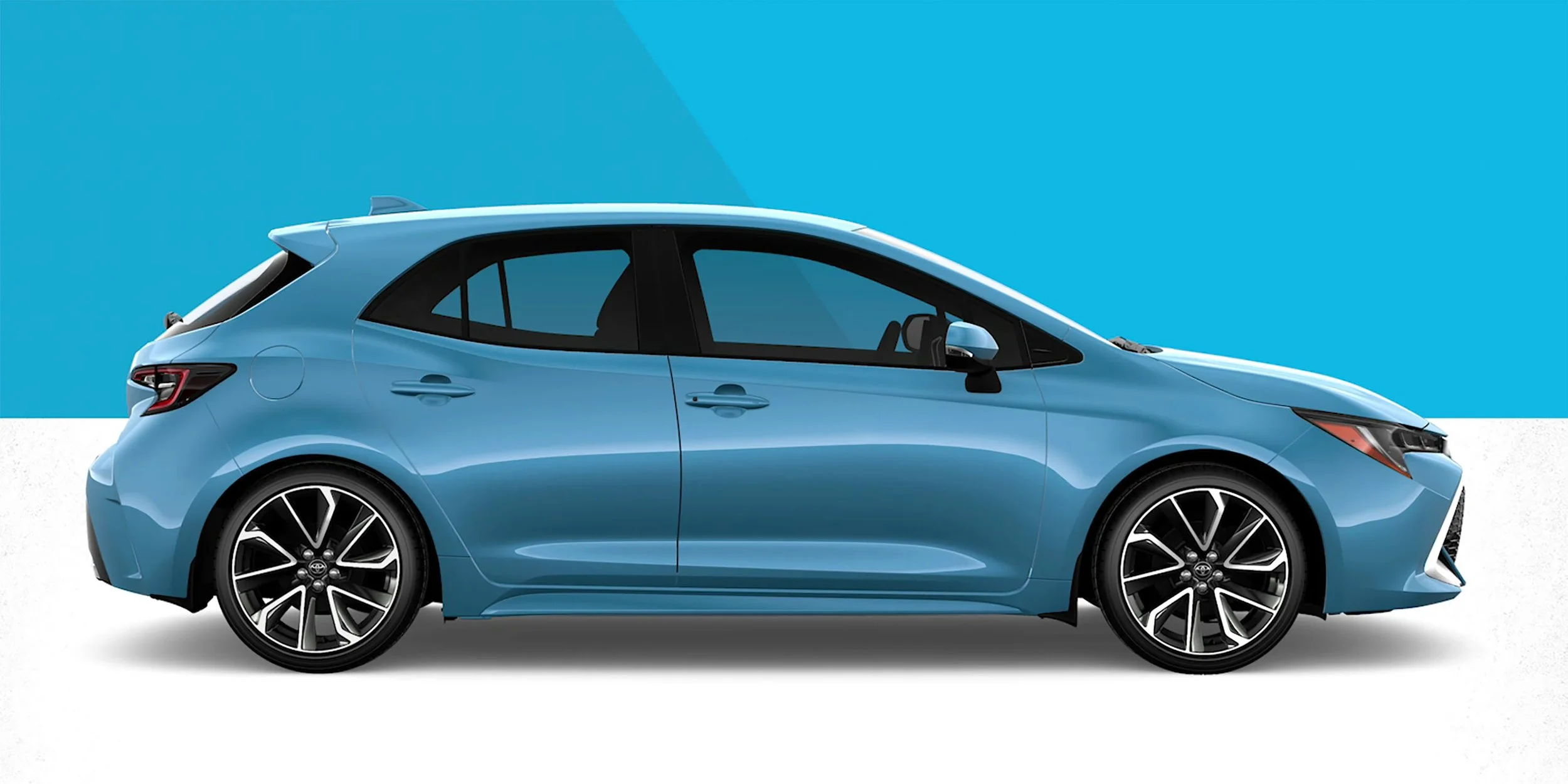 Side view of a blue modern hatchback car with black and silver alloy wheels, set against a two-tone blue and white background.