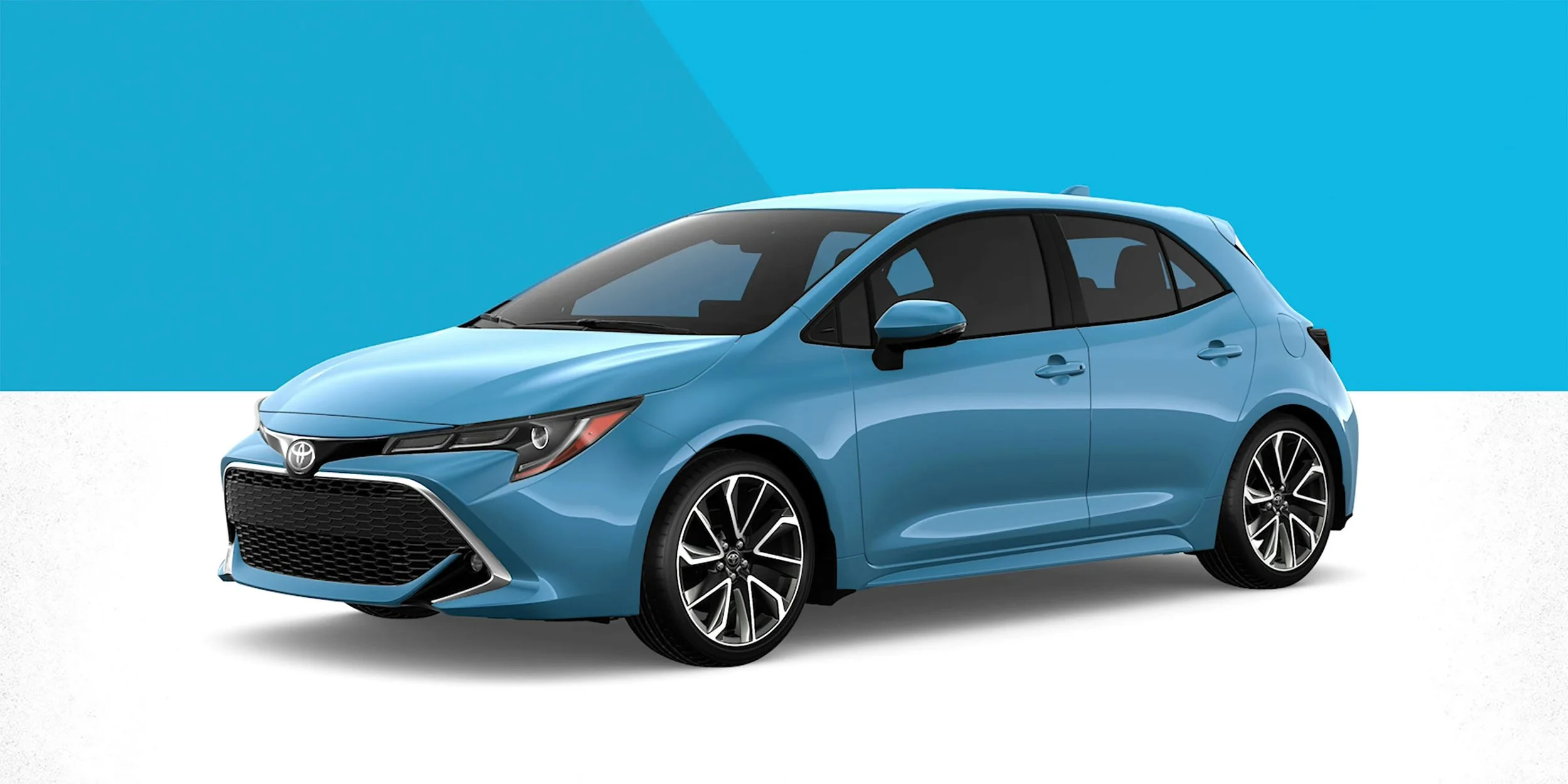A blue Toyota hatchback car with black and silver rims, shown against a background of blue and white.