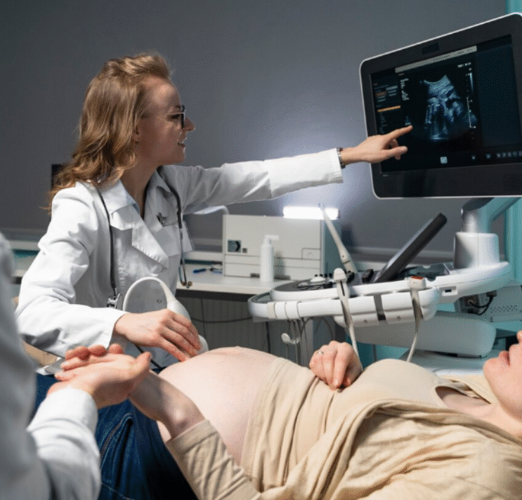 Doctor performing an ultrasound on a pregnant woman in a medical clinic.