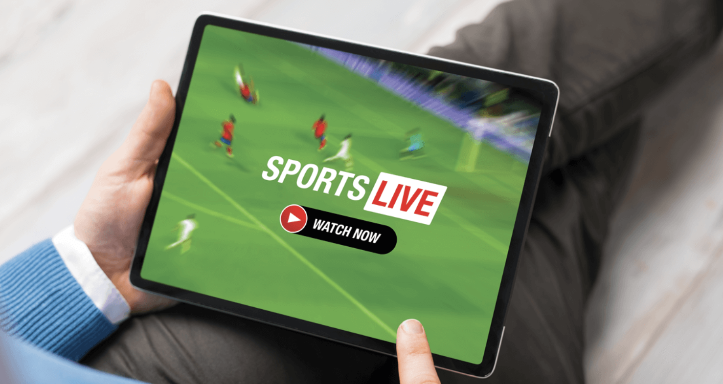 Person watching a live sports broadcast on a tablet with a "Watch Now" button