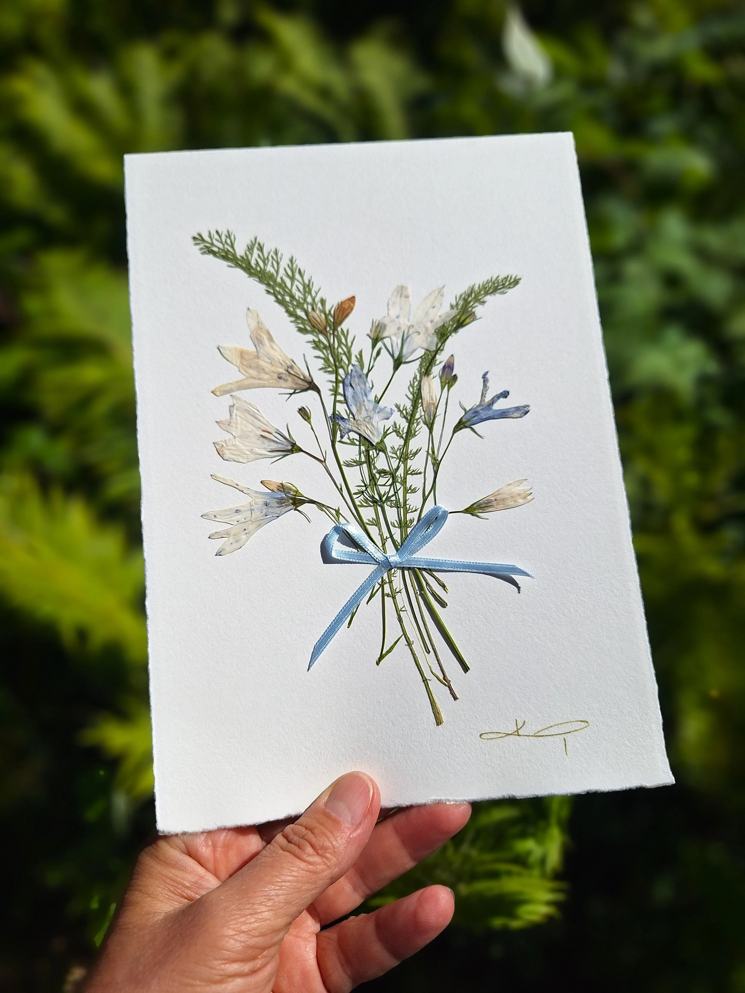 An A5 double-fold unique greeting card handcrafted with care using authentic, hand-sourced pressed bellflowers.