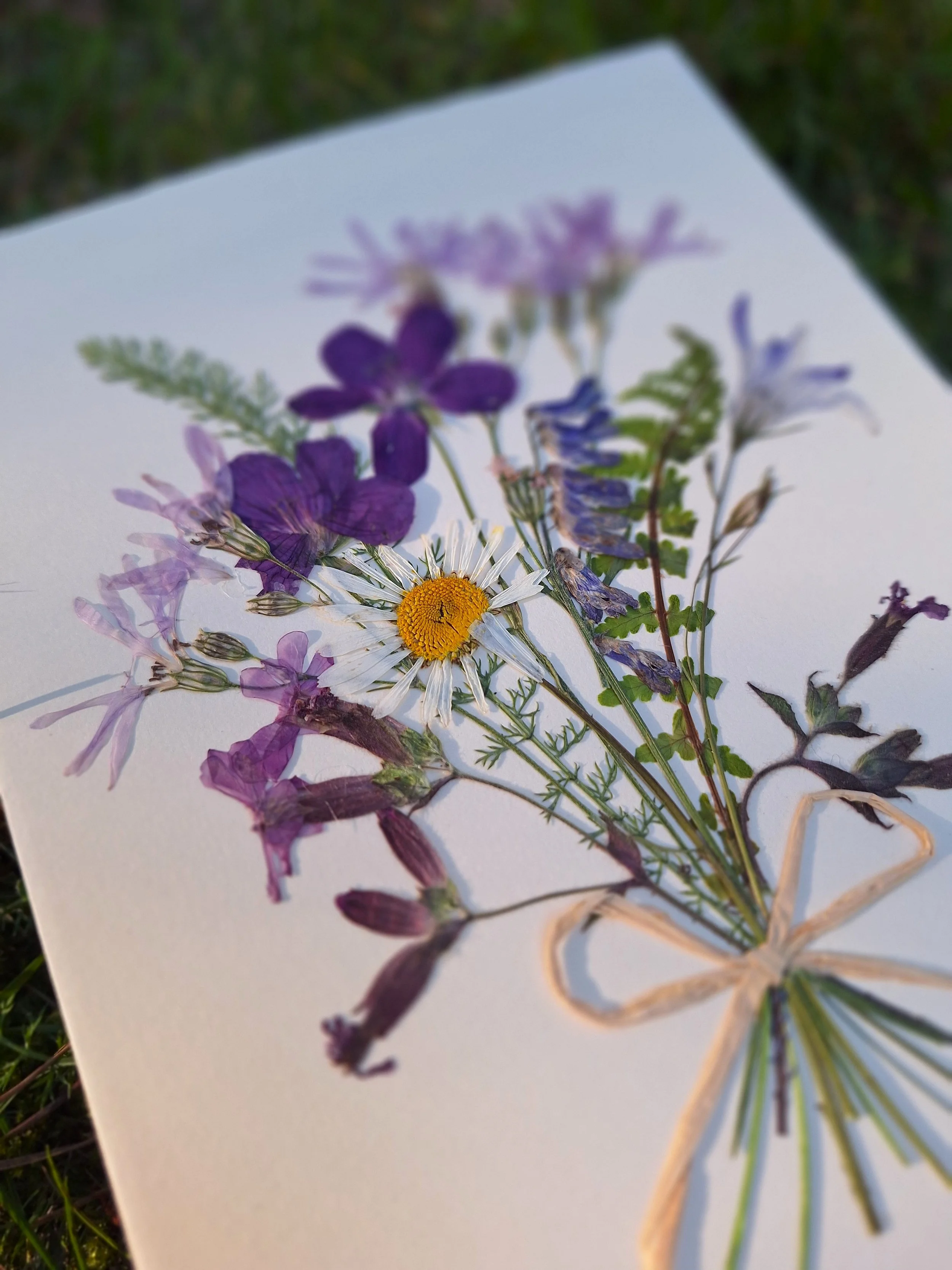 A pressed flower greeting card with joyful wildflowers bouquet