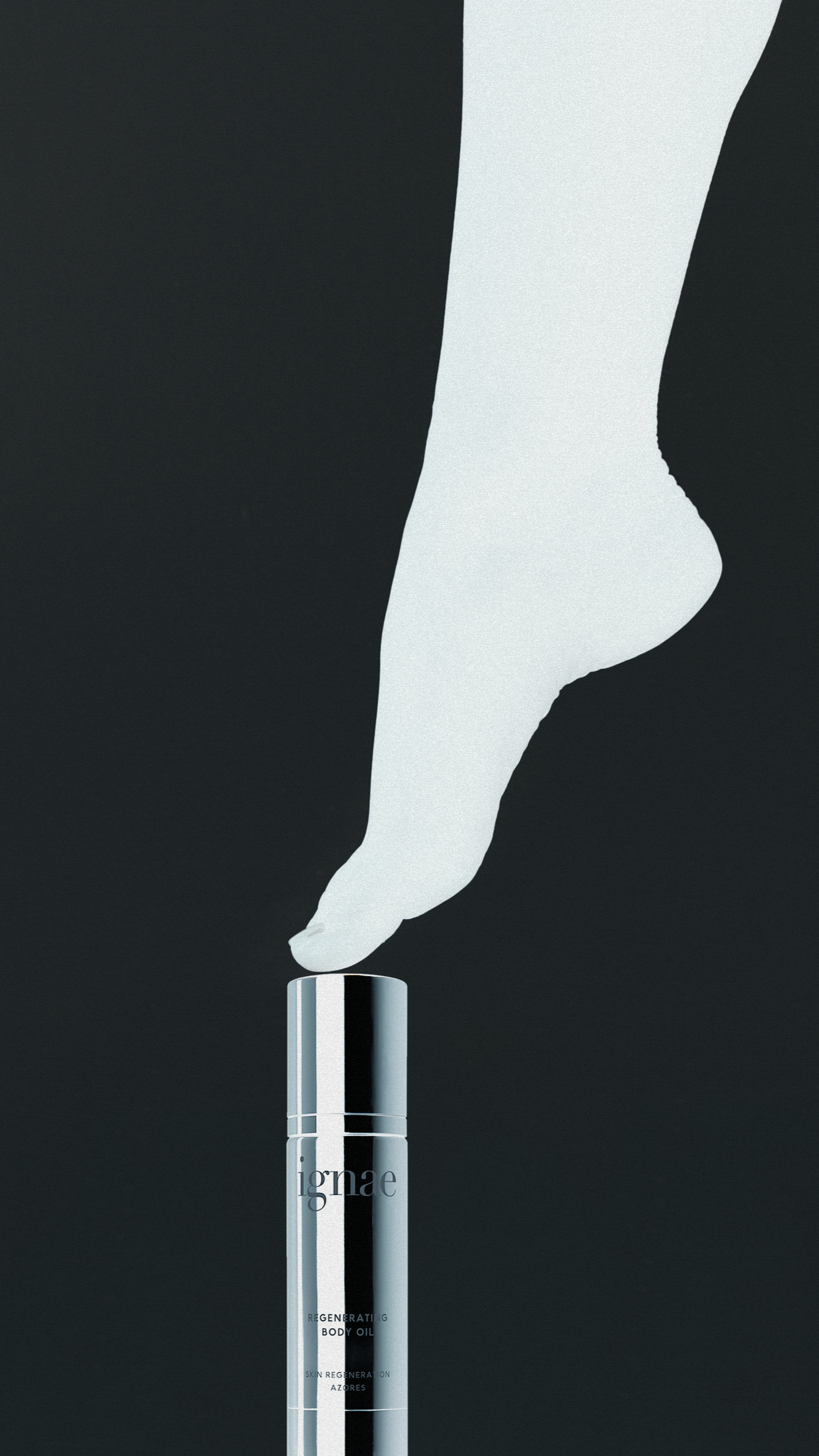 A bottle of Ignite regenerating body oil with white smoke rising from the opening.