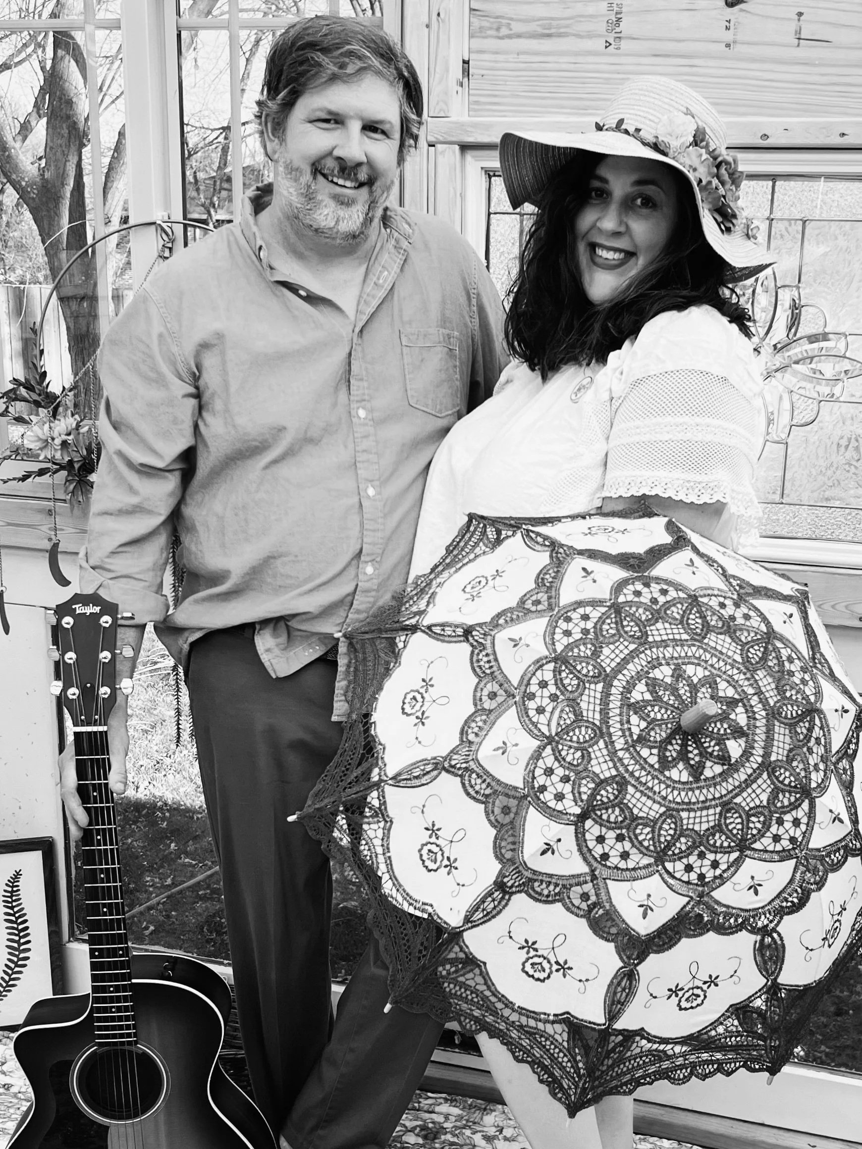 Aaron Lipp and Caroline Lipp of The Wandering Tulipps smiling together with an acoustic guitar, reflecting the warmth and harmony of their Indiana folk and Americana music.