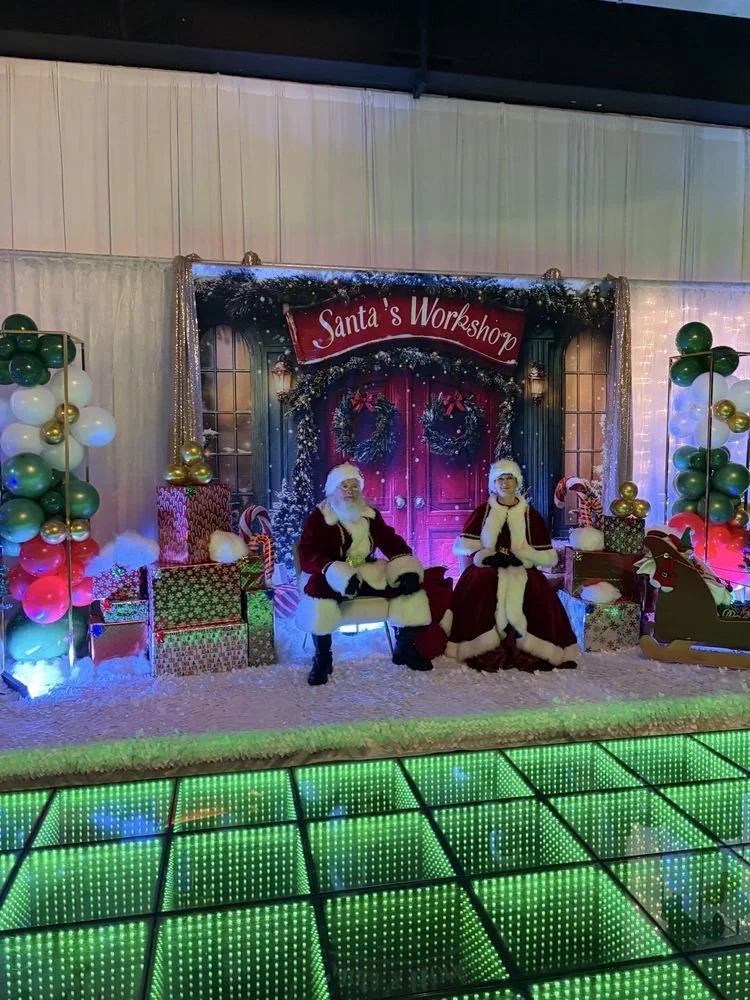 Santa and Mrs. Clause posing for photos
