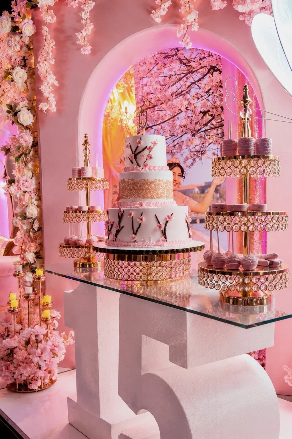 A cherry blossom themed cake with desserts.