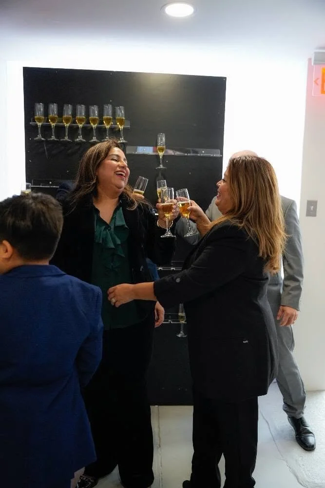 Two women smiling and cheers
