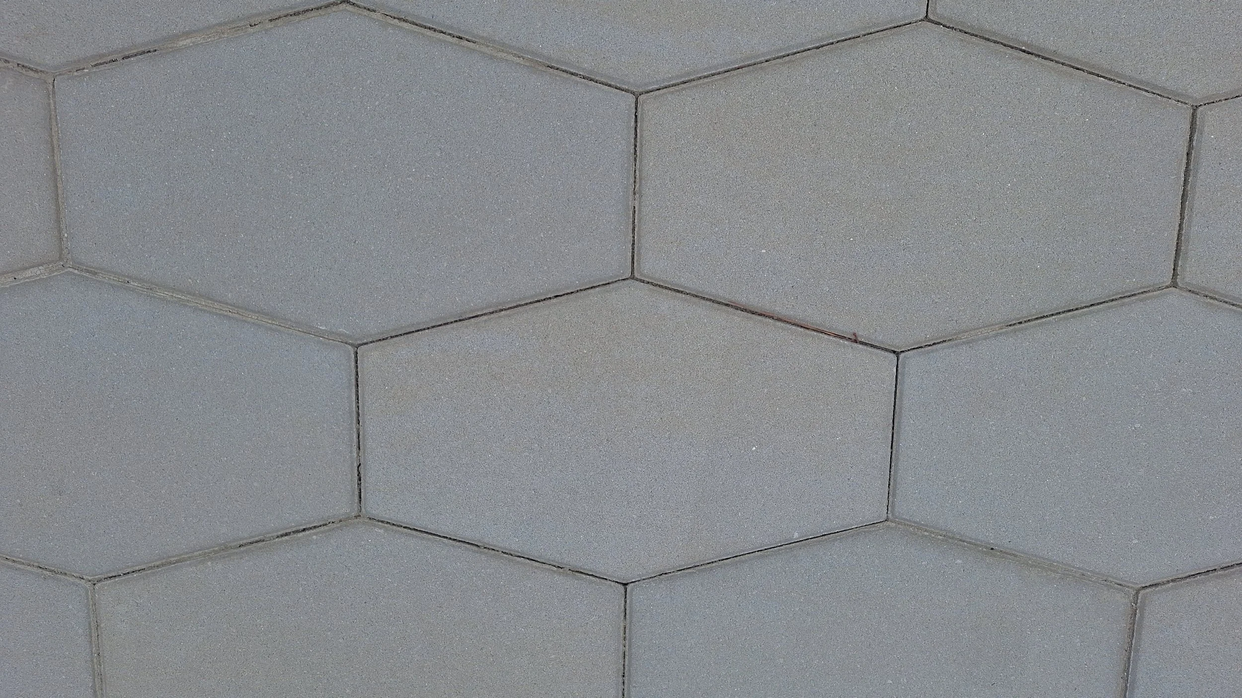 Close-up of gray concrete block wall with mortar joints.