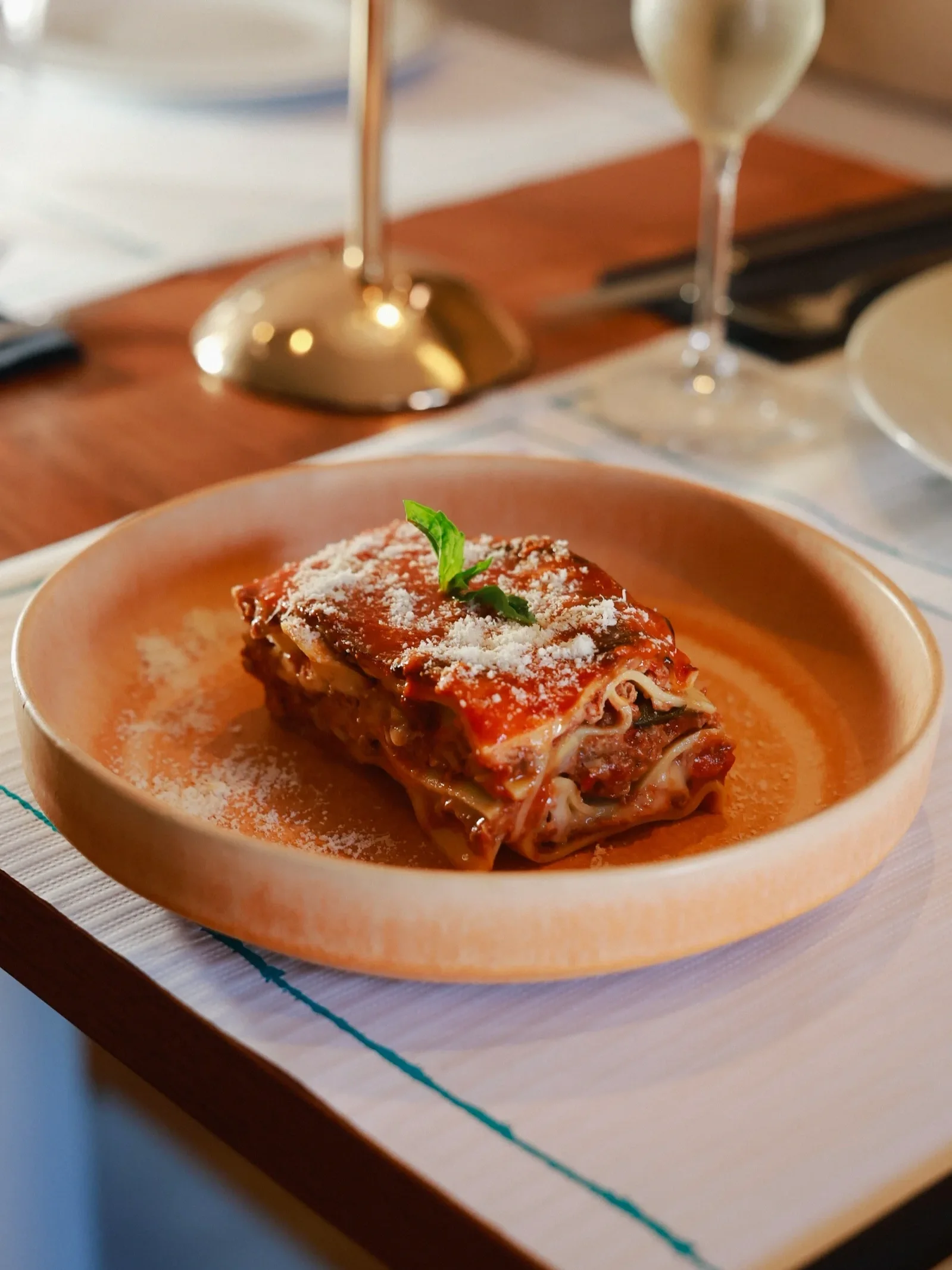 Lasagna alla Bolognese at VERA Ristorante in Porto: layered fresh pasta with slow-cooked ragù, béchamel and grated Parmigiano, topped with basil.