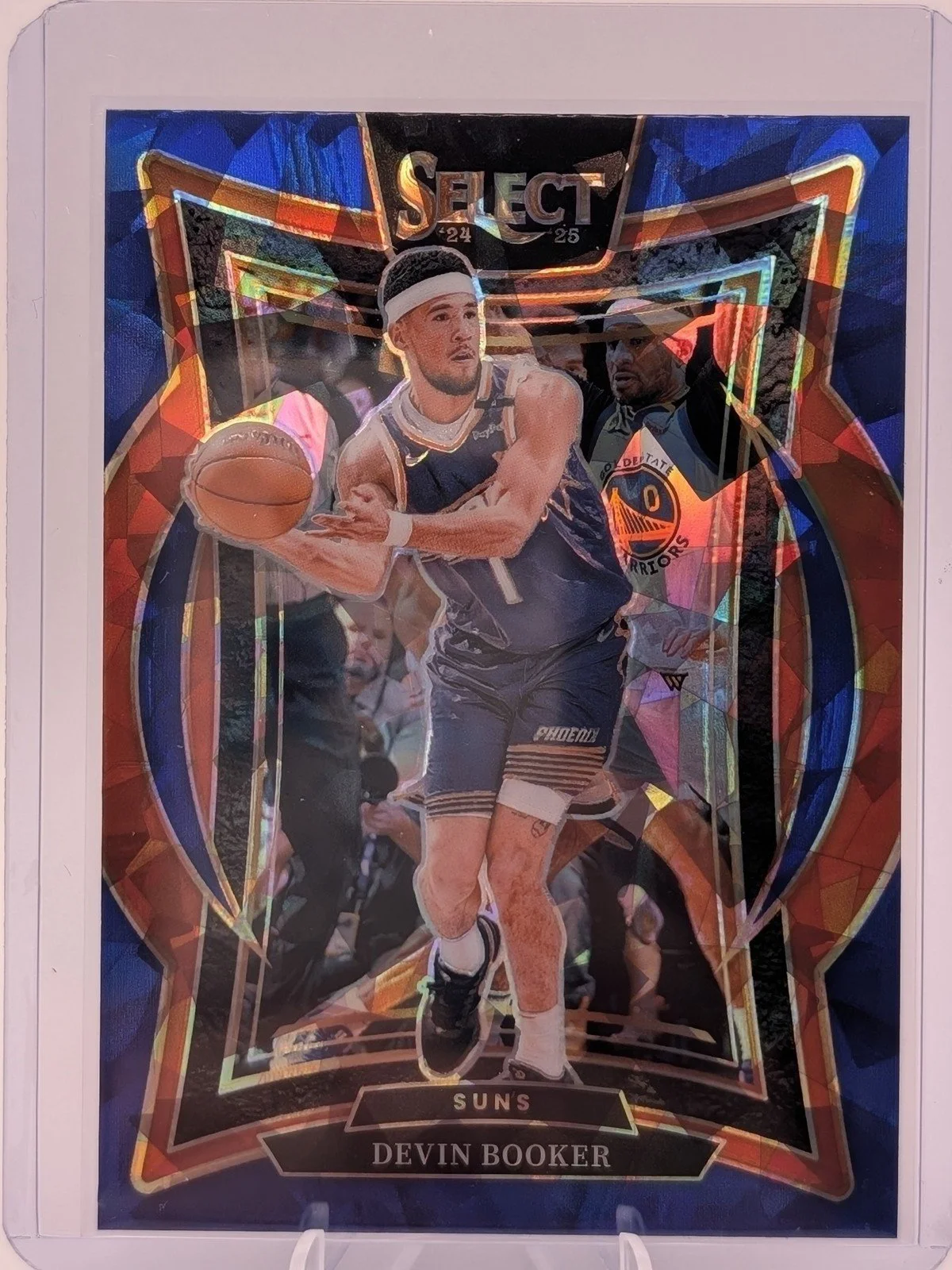 Front of 2024-25 Panini Select #16 Devin Booker Blue Cracked Ice Prizm