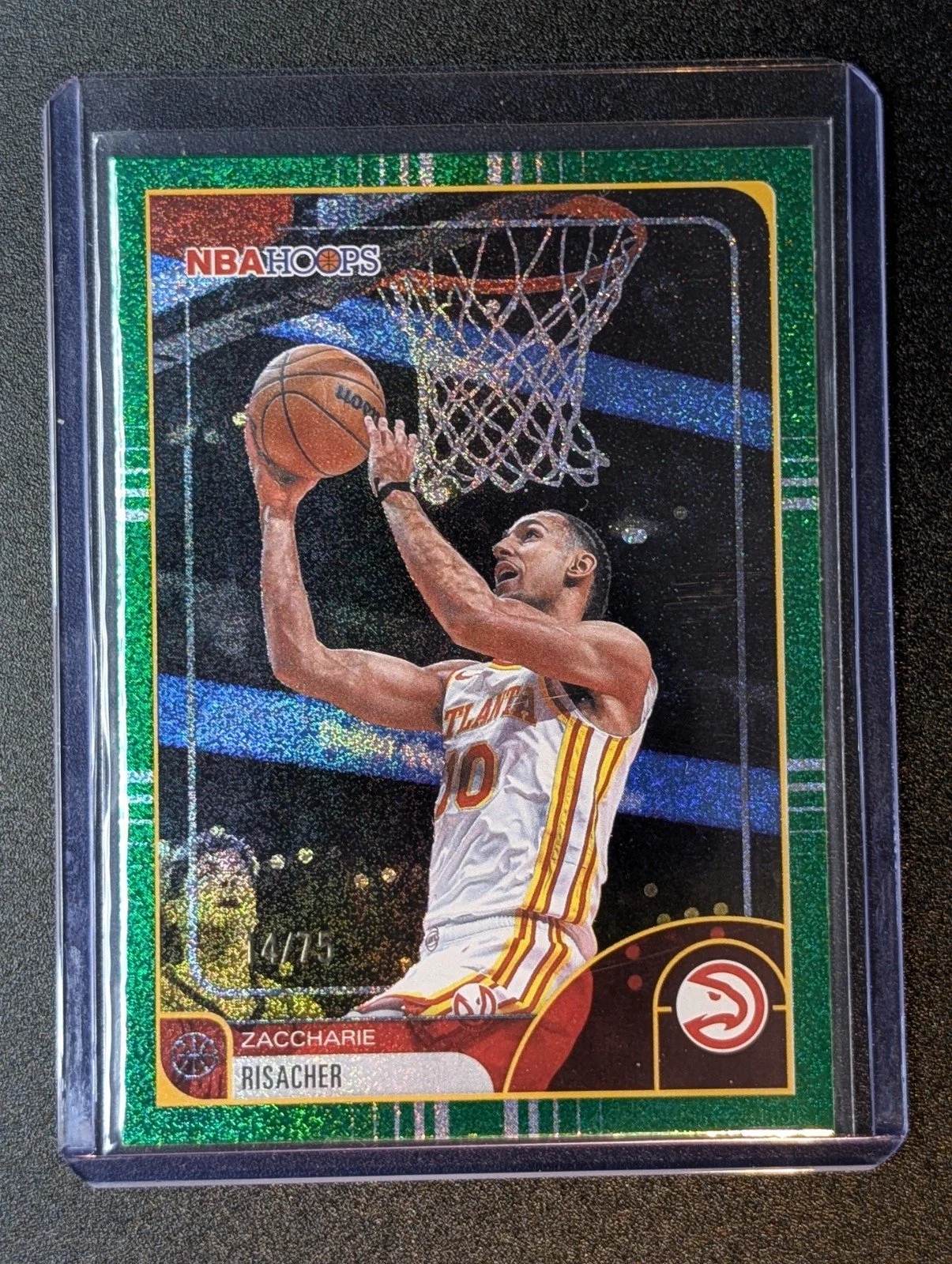 Front of 2025-26 Hoops #105 Zaccharie Risacher Light Burst Green /75