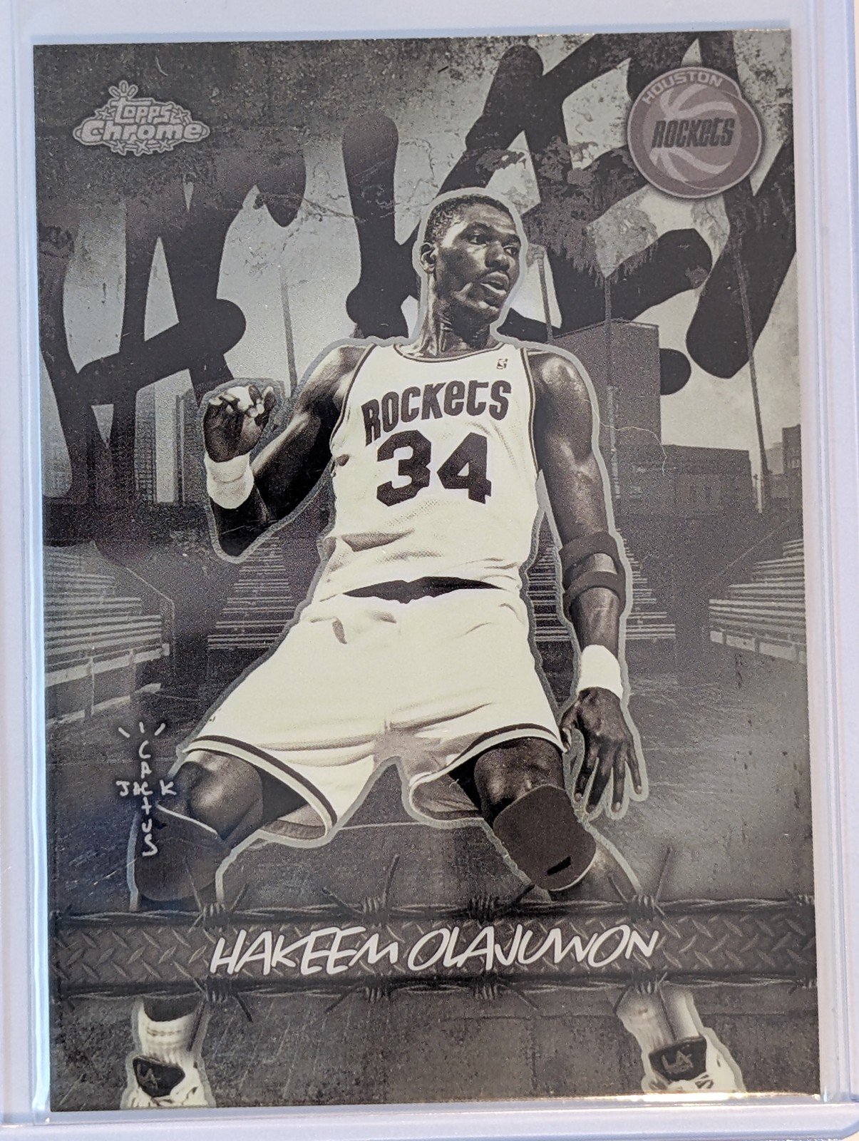 Front of 2025-26 Topps Chrome Cactus Jack #JU-39 Hakeem Olajuwon Jacked Up