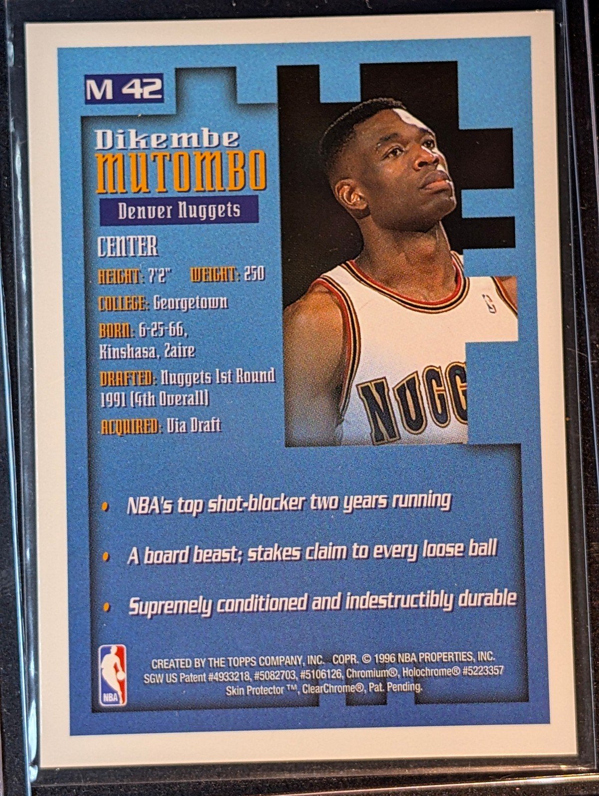 Back of 1995-96 Finest #M42 Dikembe Mutombo Mystery Borderless Silver