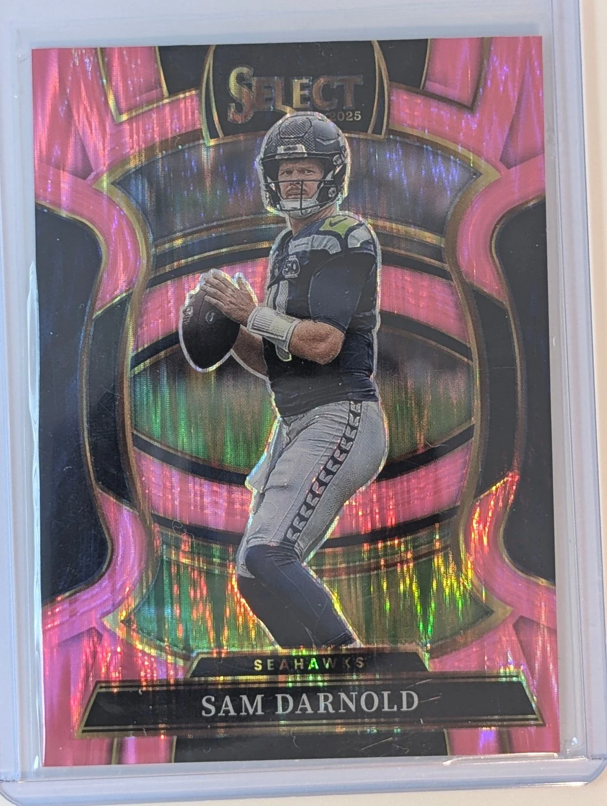 Front of 2025 Panini Select #13 Sam Darnold Pink Prizm Shock