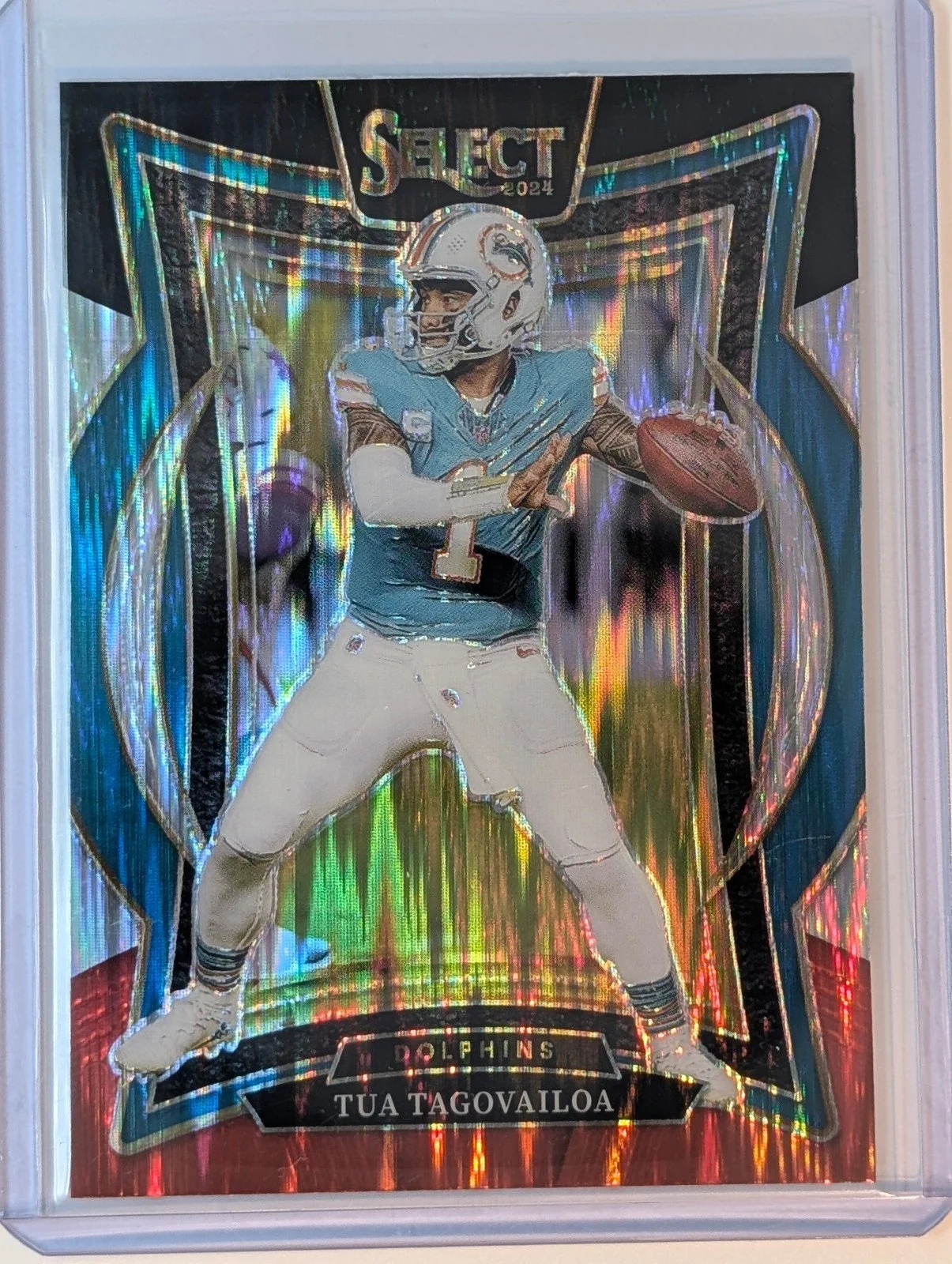Front of 2024 Panini Select #99 Tua Tagovailoa Black & Red Prizm Shock
