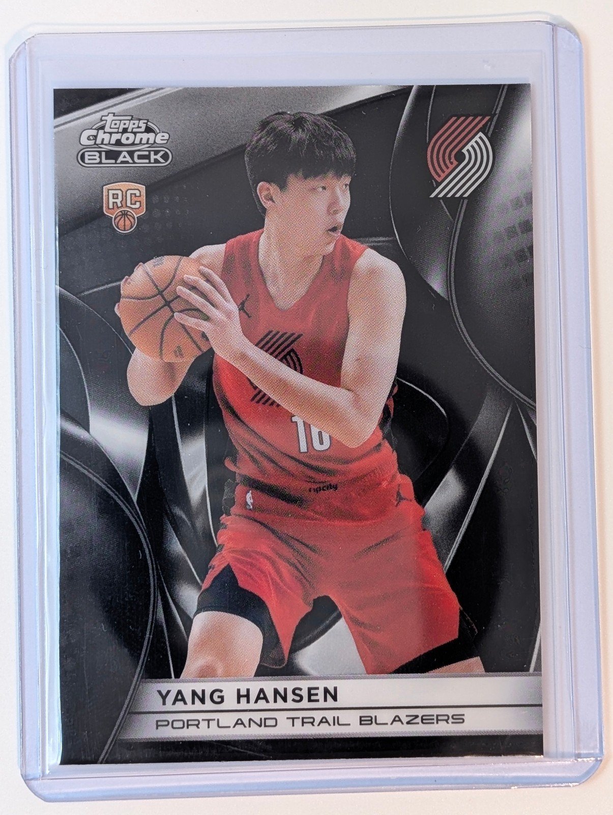 Front of 2025-26 Topps Chrome Black #116 Yang Hansen RC