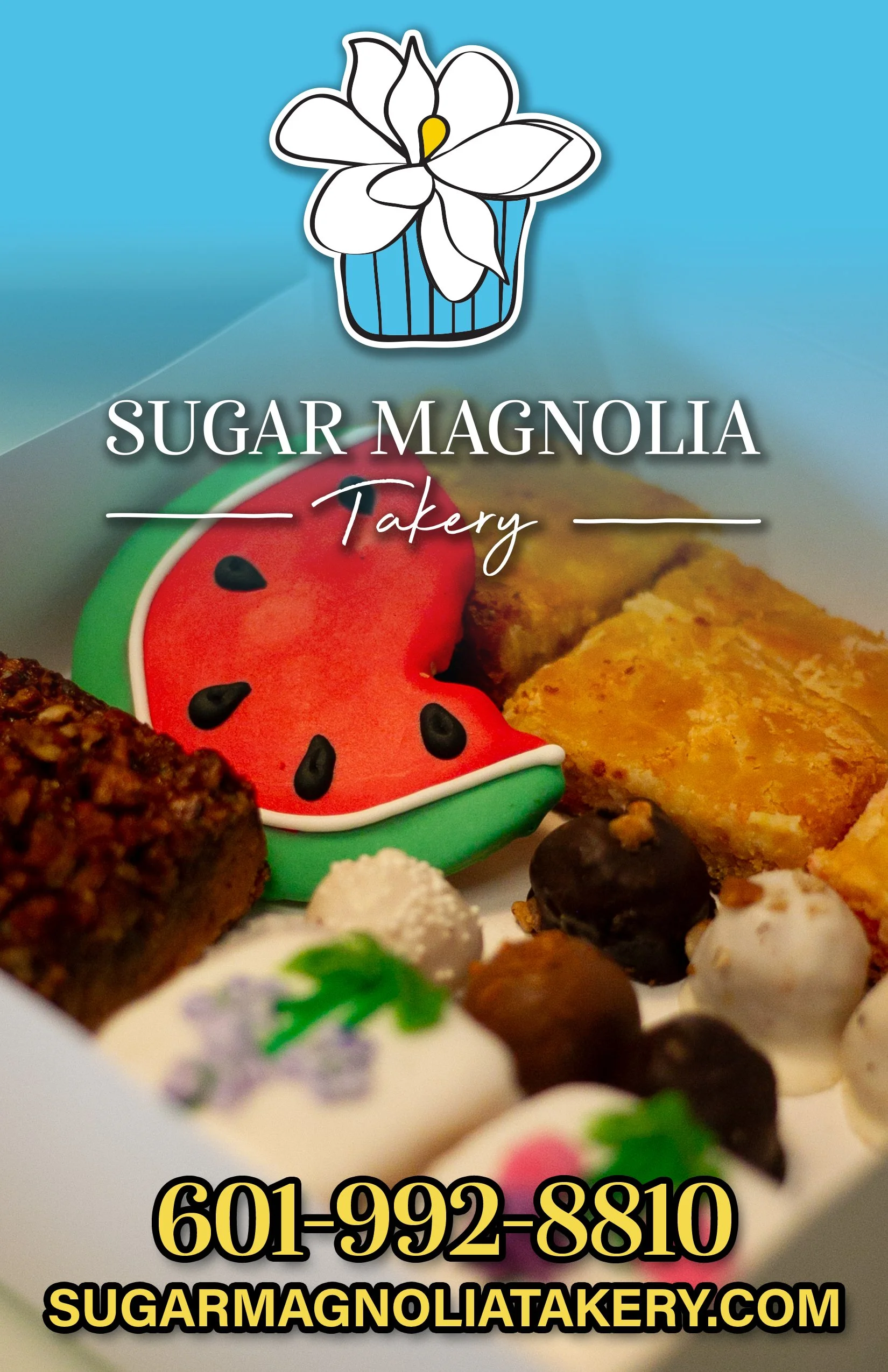 A variety of decorated cookies and treats with the logo of Sugar Magnolia Bakery, featuring a white magnolia flower, above text with phone number 601-992-8810 and website sugarmagnoliatakeries.com.