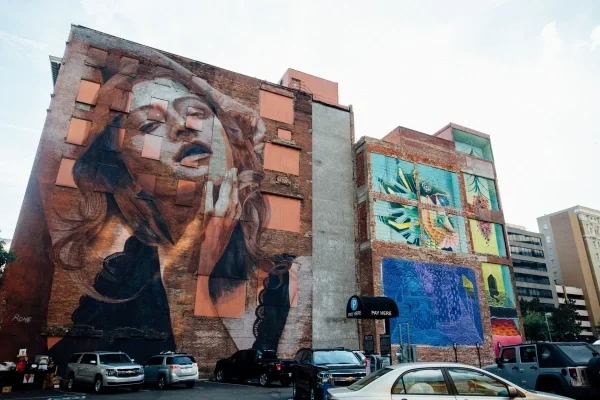 Large mural on building of woman