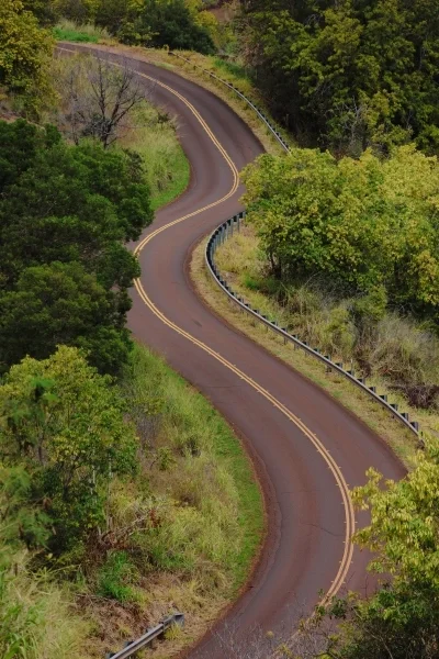 Winding road through lush hilly landscape