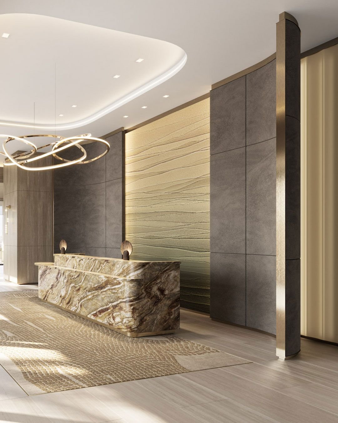 Modern hotel lobby with a marble reception desk, textured beige wall art behind it, and contemporary lighting fixtures.
