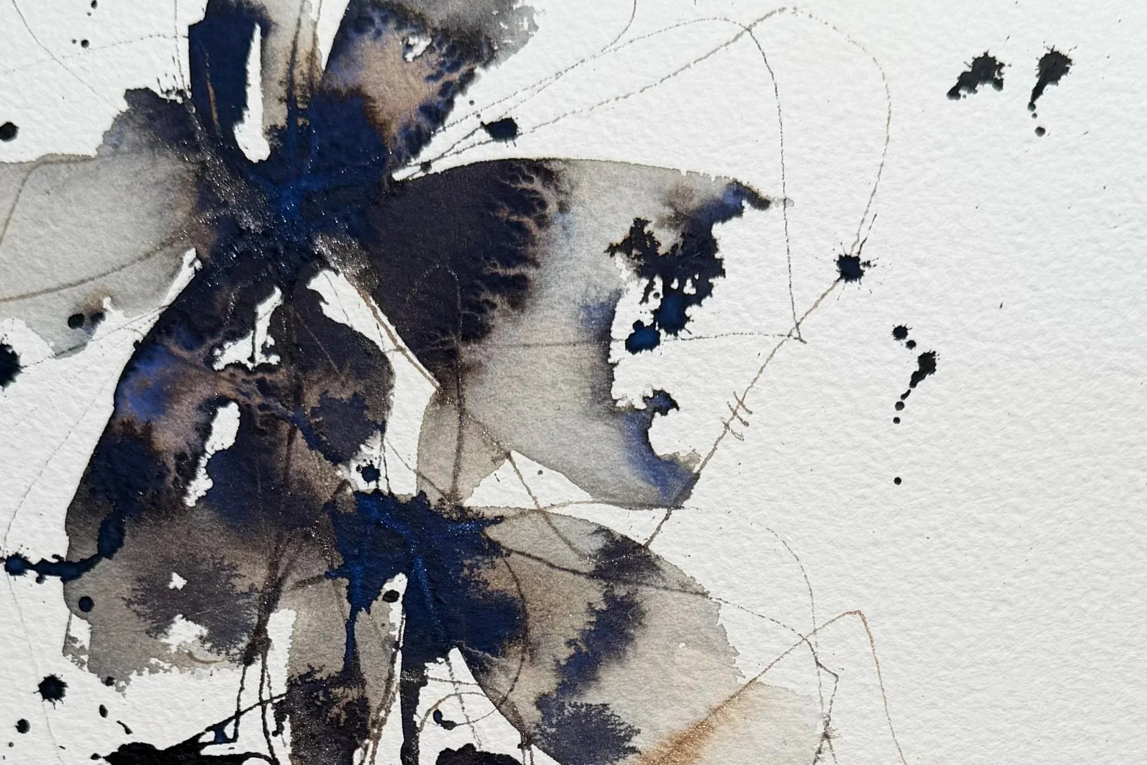 Abstract watercolor painting with splashes of dark blue, gray, black, and brown ink on textured paper.