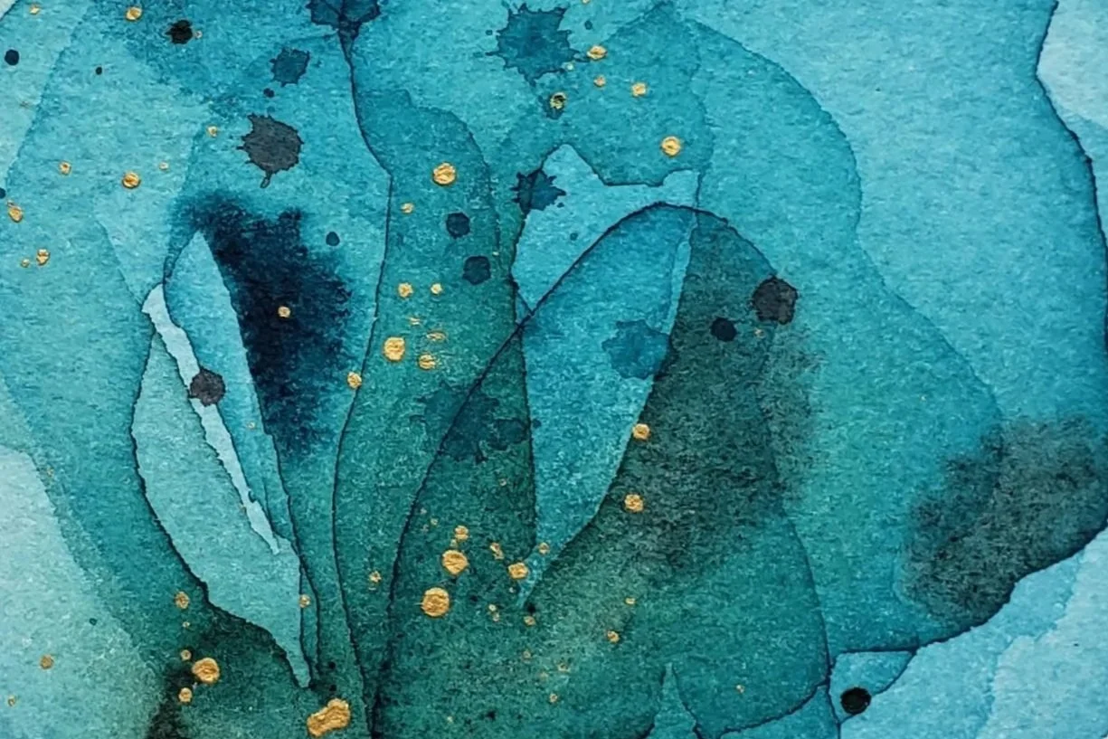 Abstract watercolor painting with shades of blue and teal, accented with scattered gold splatters.