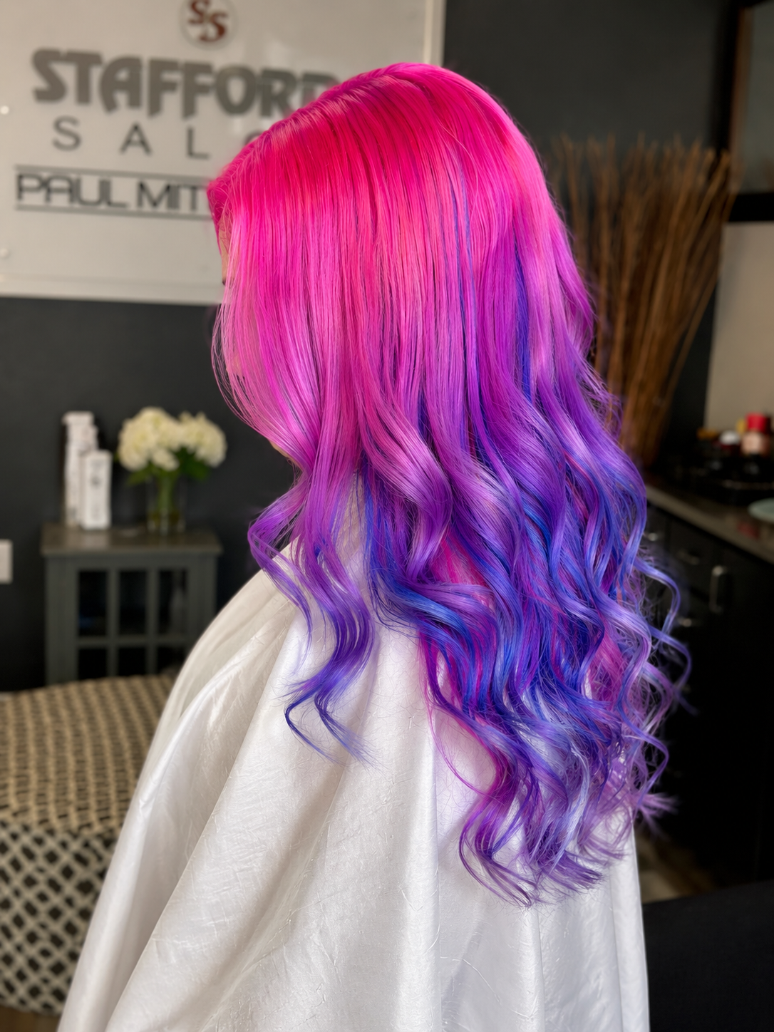 Colorful rainbow hair with pink, purple, and blue curls.