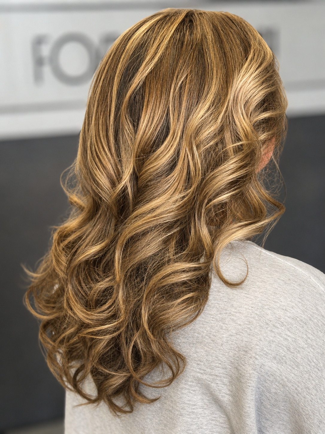 A woman with long, blond, curly hair.