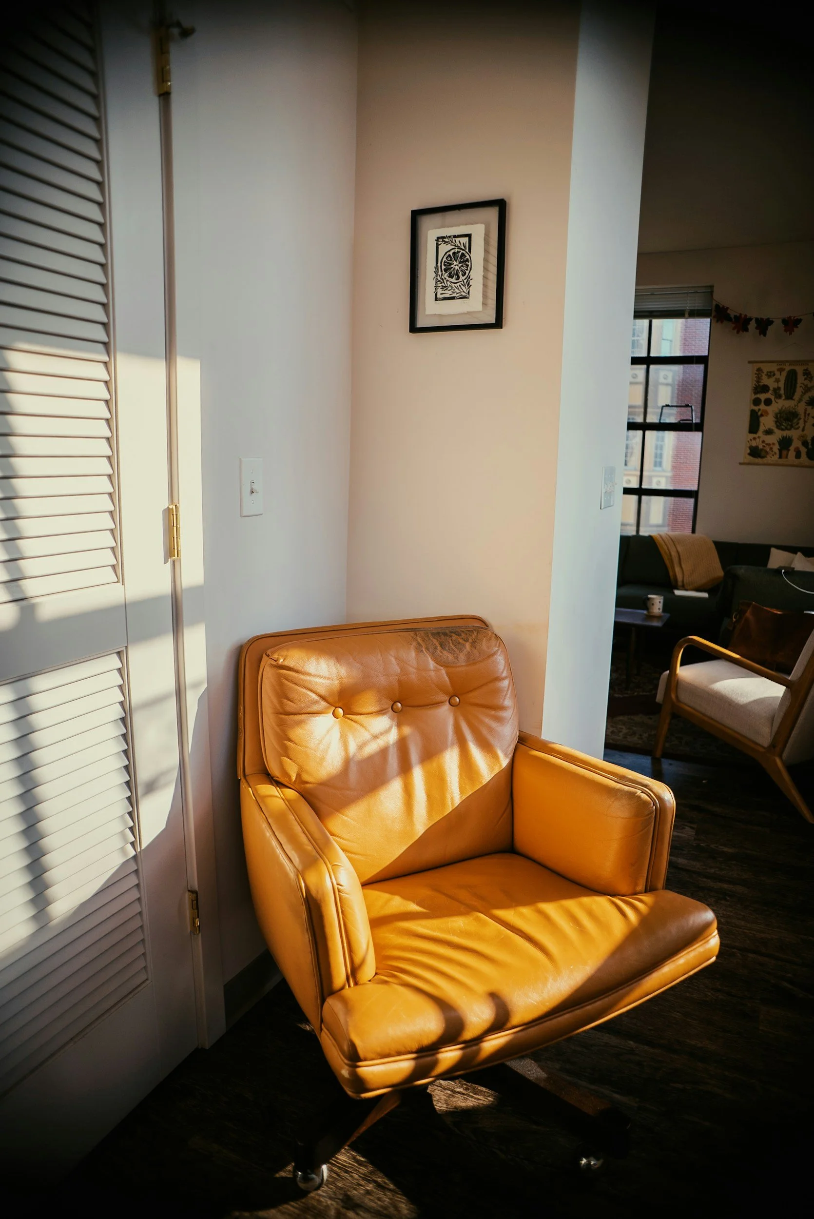 Warm therapy space featuring a brown chair and soft sunlight, representing safety, comfort, and a supportive environment for healing