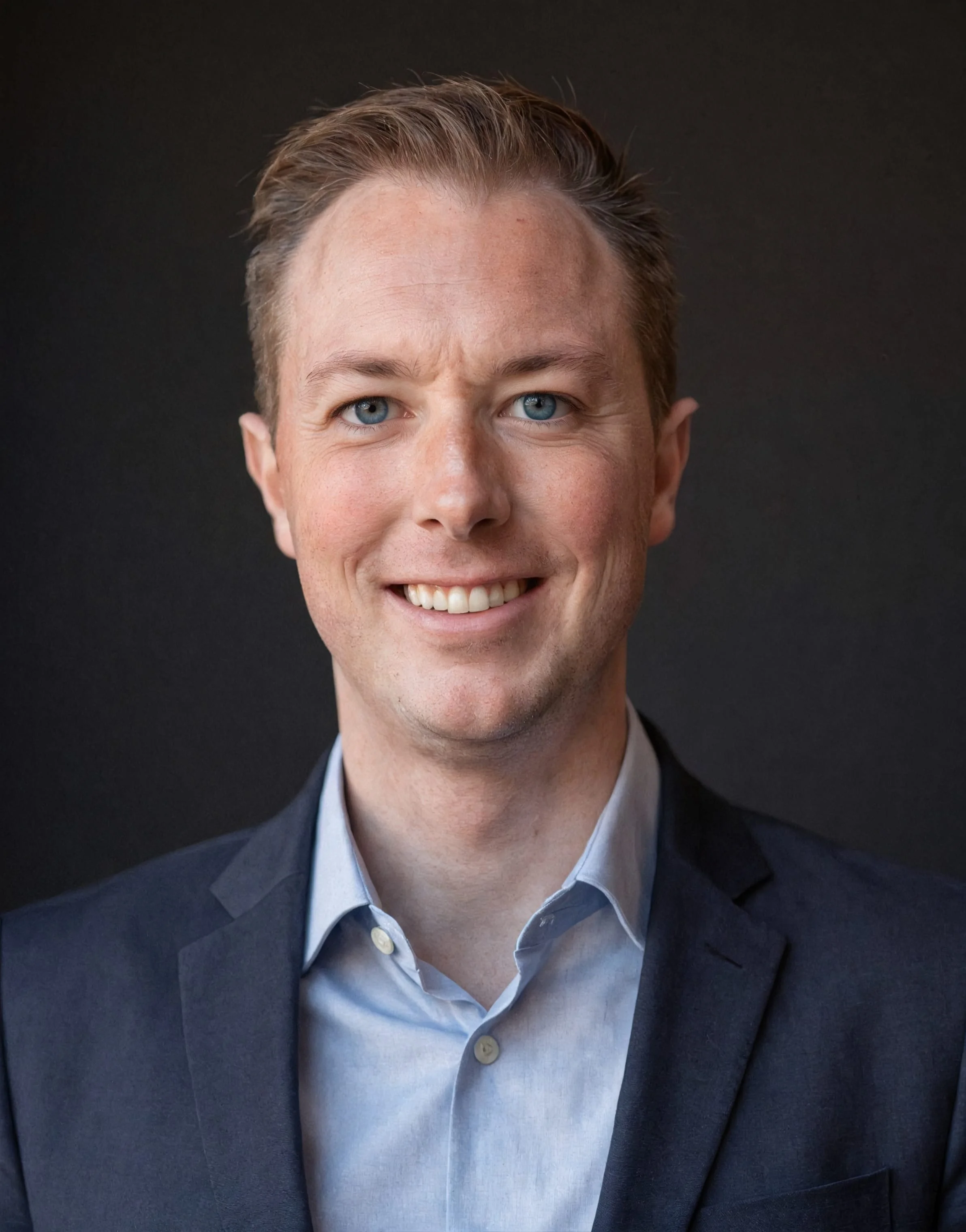 Trevor Braaten, professional headshot in a dark suit.