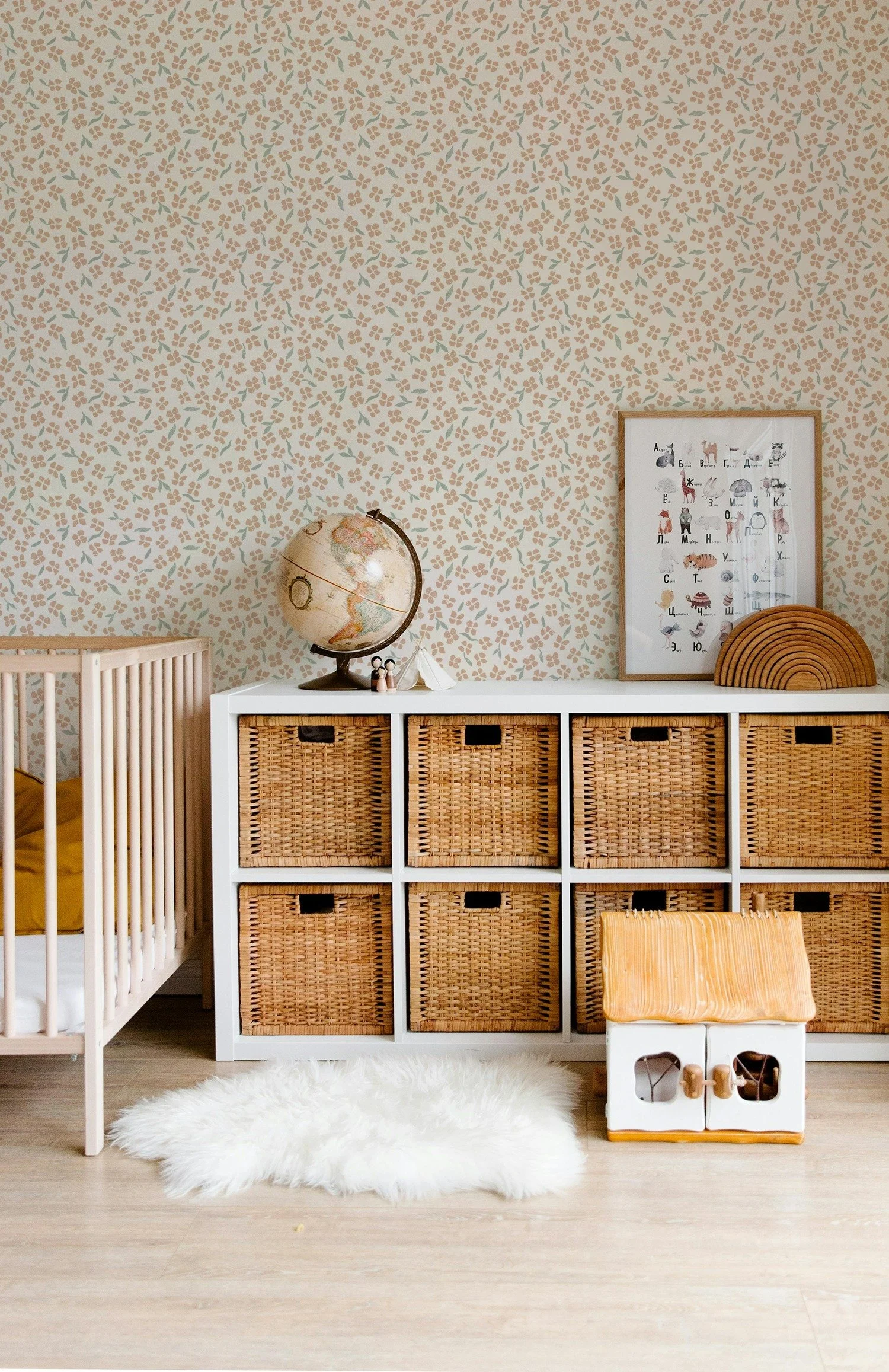 baby nursery room showing wallpaper in ditsy pink florals cottagecore style