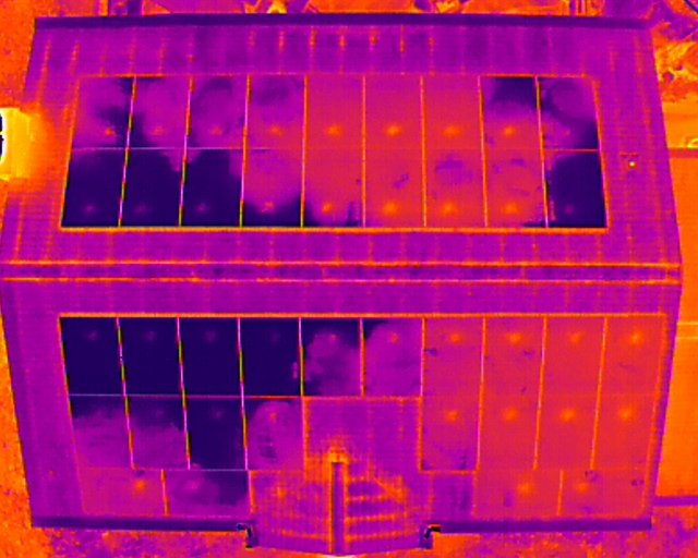 Infrared image of a two-story house showing roof and upper windows.