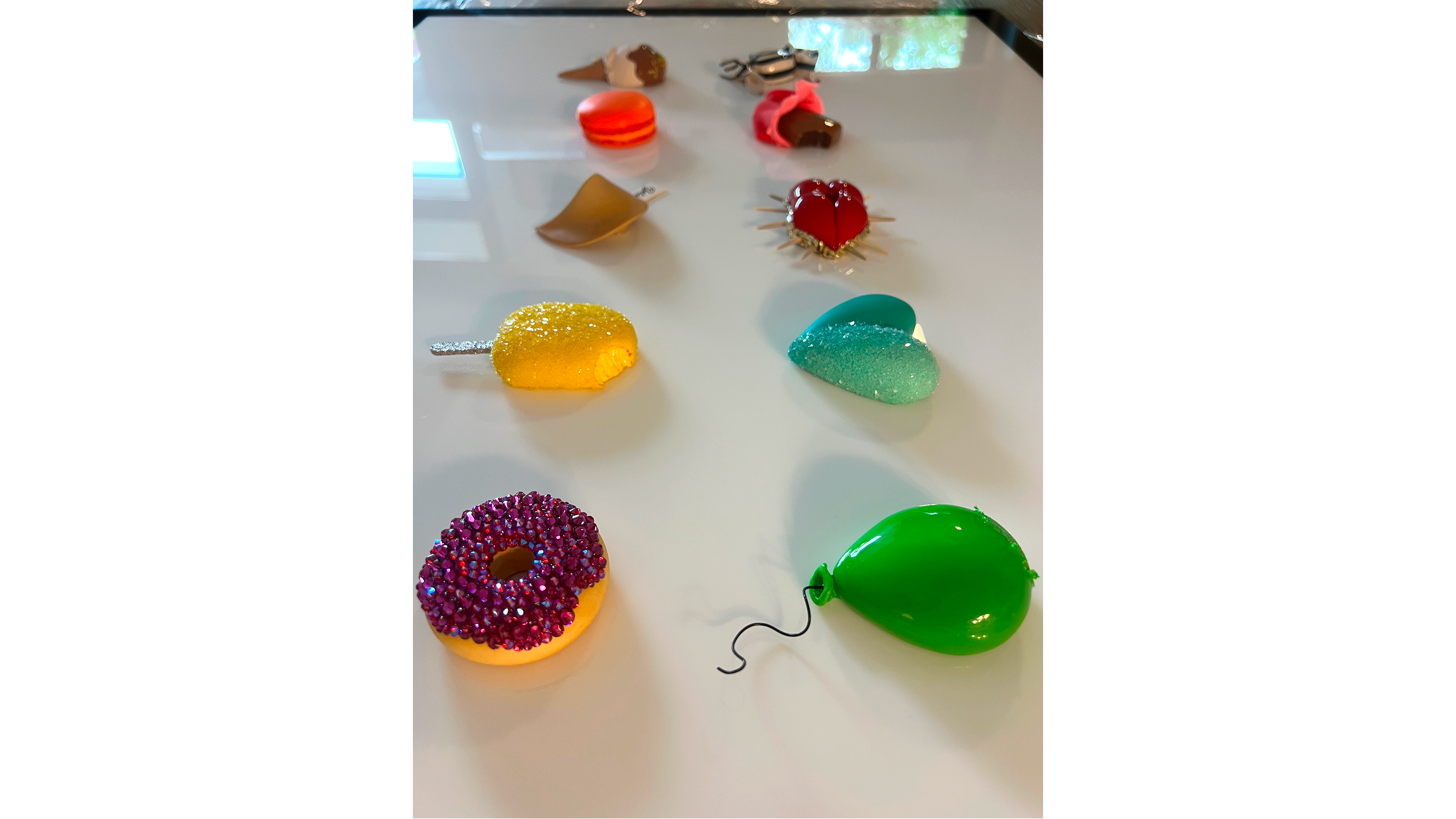 Various colorful balloons and decorative items on a white surface.