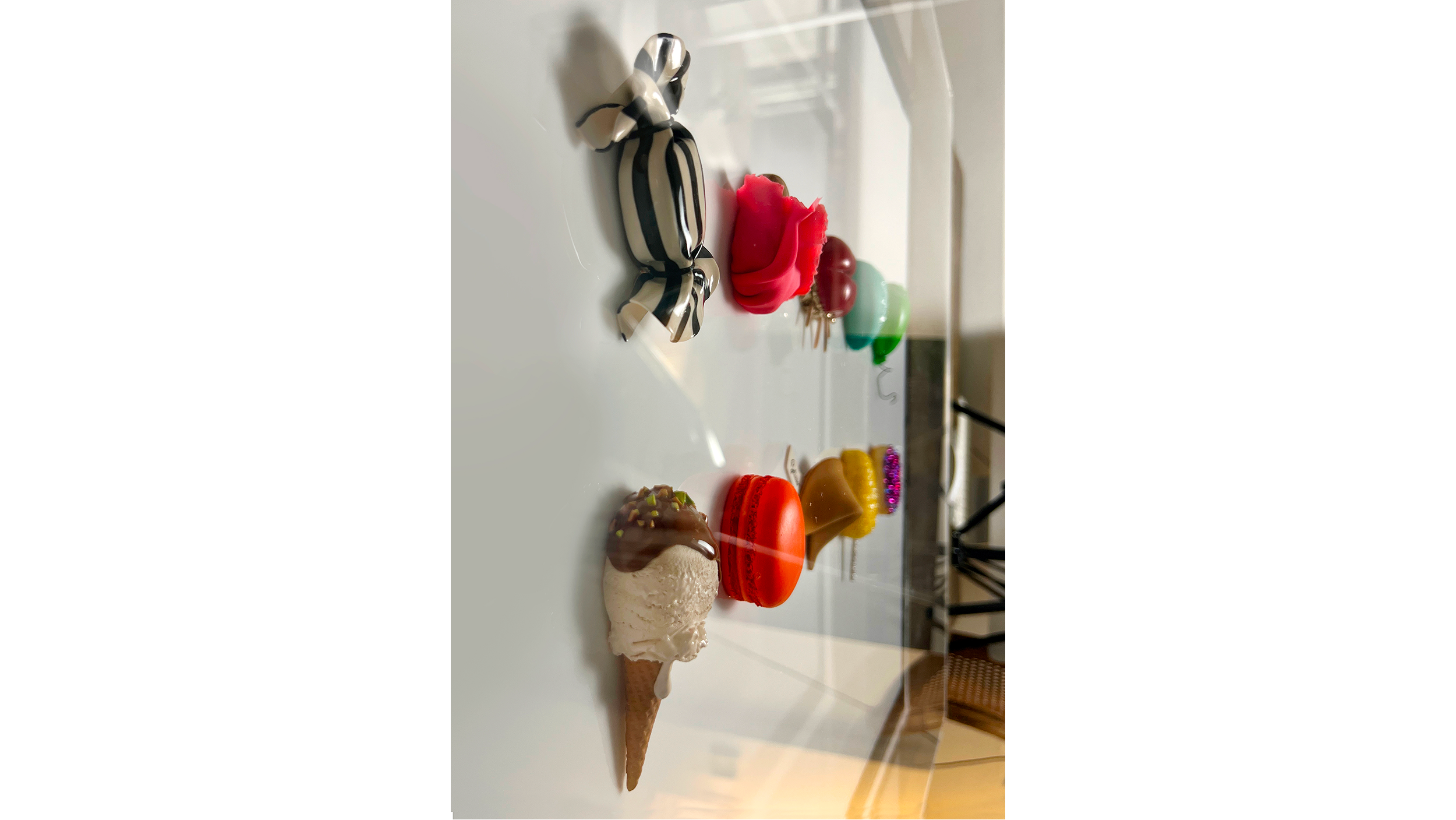 Assorted colorful ice cream and candies on a white table.