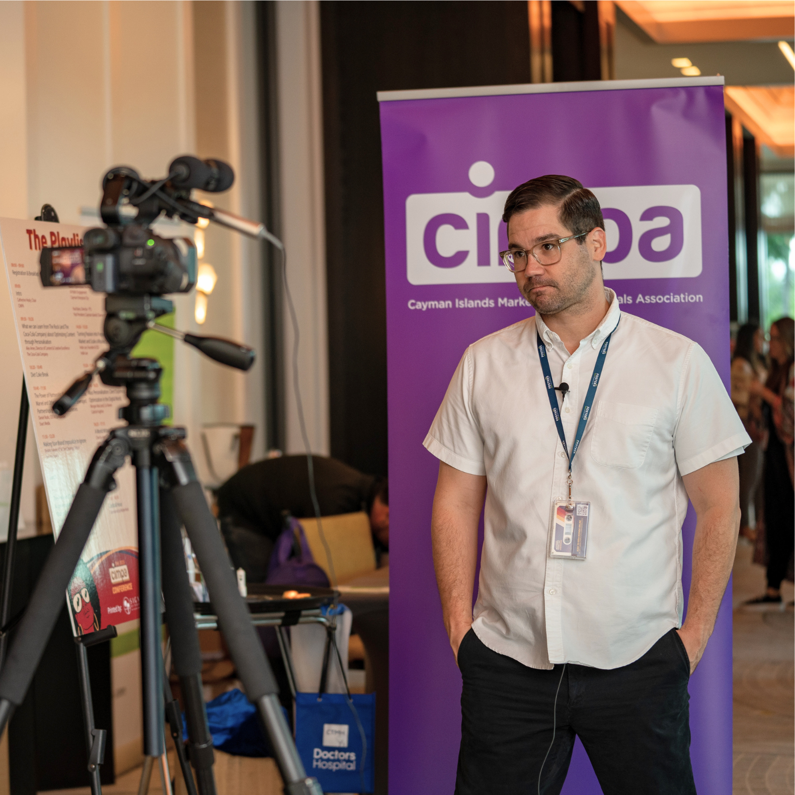A behind the scenes shot of a conference speaker being interviewed on camera.