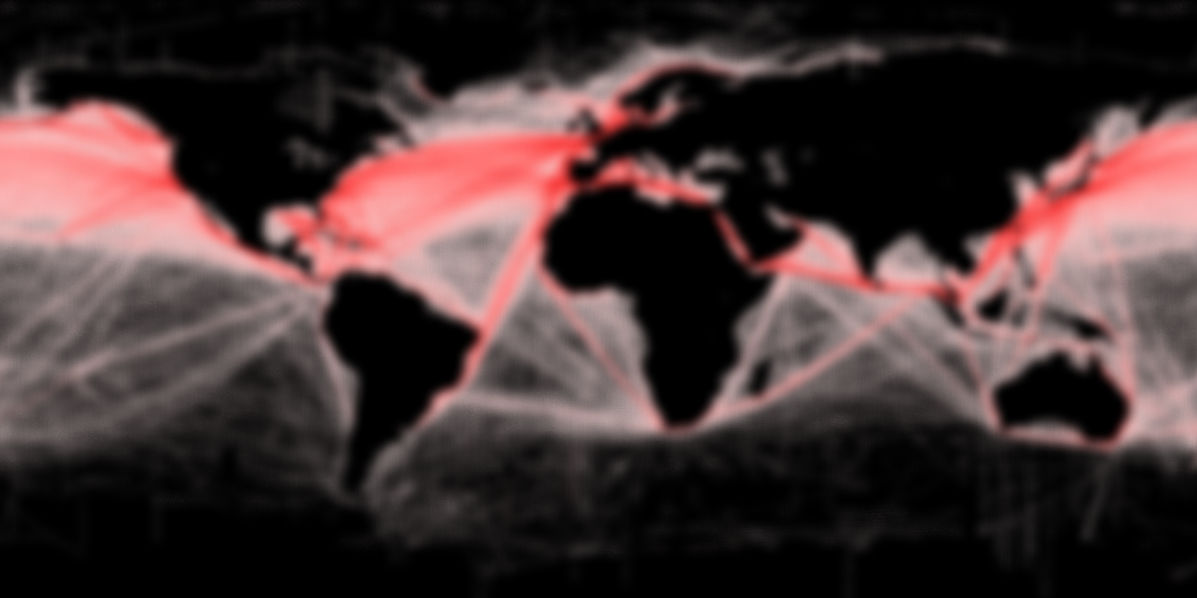 Blurred map of the world with red lines connecting different continents.