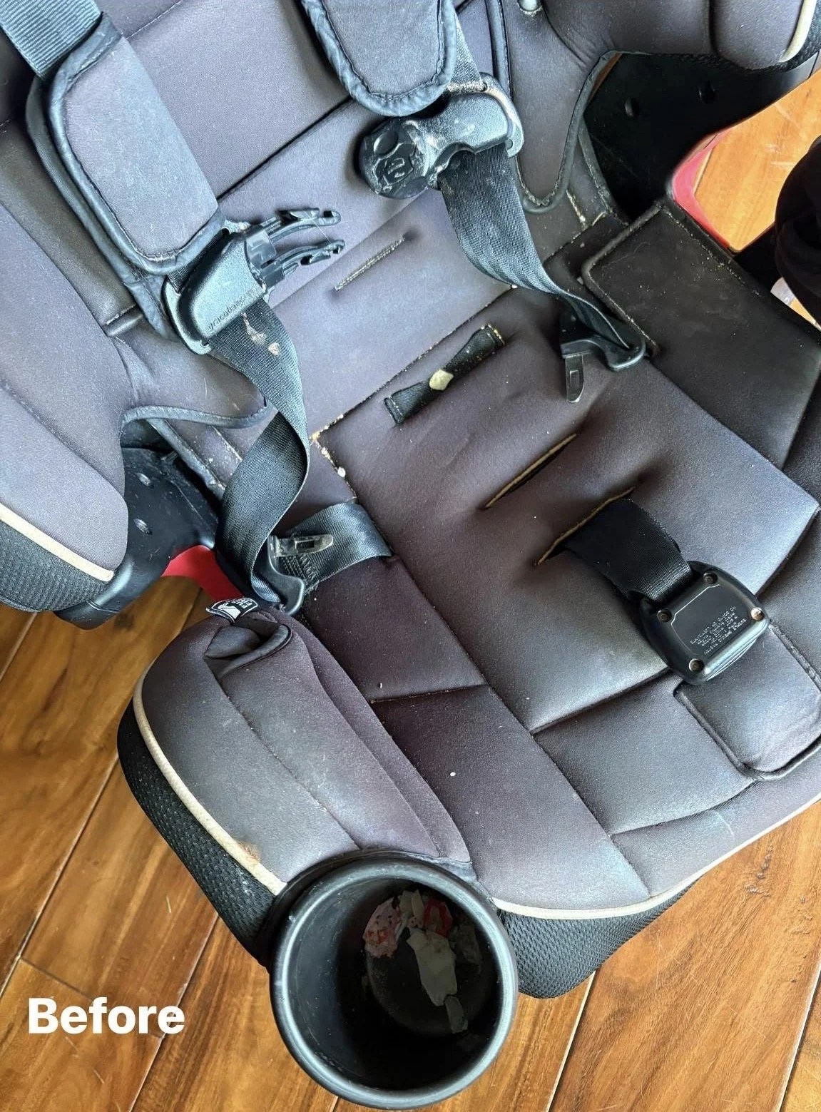 A car seat with a seat belt, some tools, and a cup holder containing trash, with the word 'Before' in the bottom left corner.