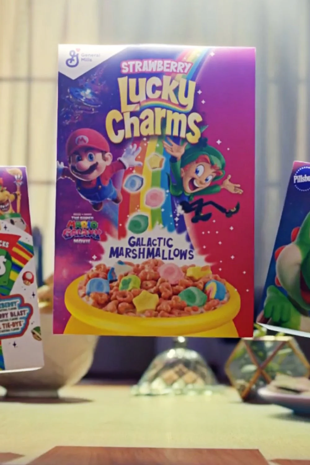A still image from the General Mills and Super Mario Galaxy Movie ad campaign featuring characters from the Mario and Nintendo universe on boxes of General Mills cereal. Post Produced by Travis Preston