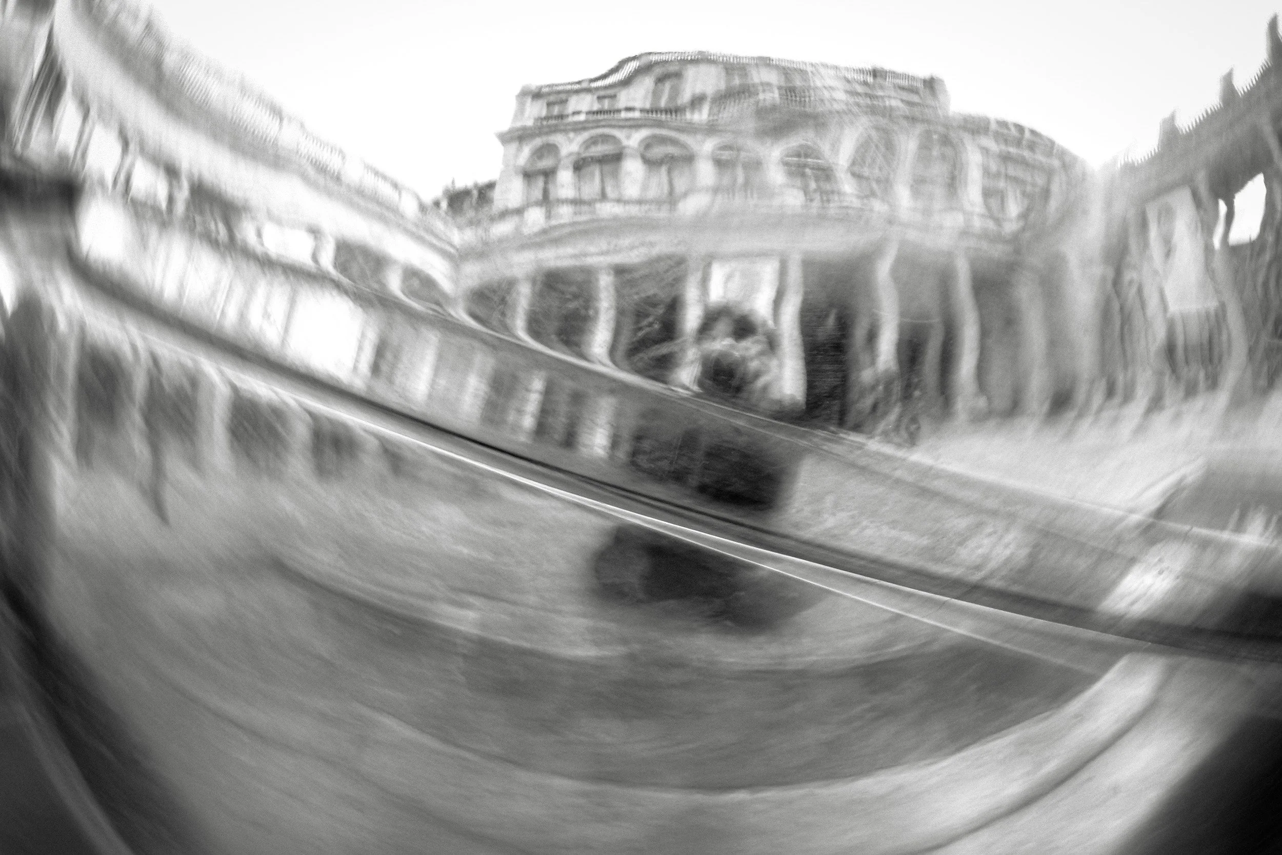 Blurry black-and-white close-up of a building's ornate architecture, possibly a historical or government structure.