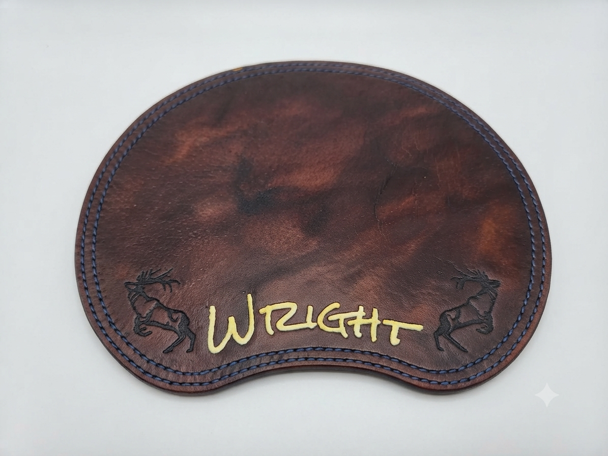 A brown leather patch with black stitched edges, embroidered with the word 'WRIGHT' in yellow, and featuring two black outlined reindeer, one on each side of the word.