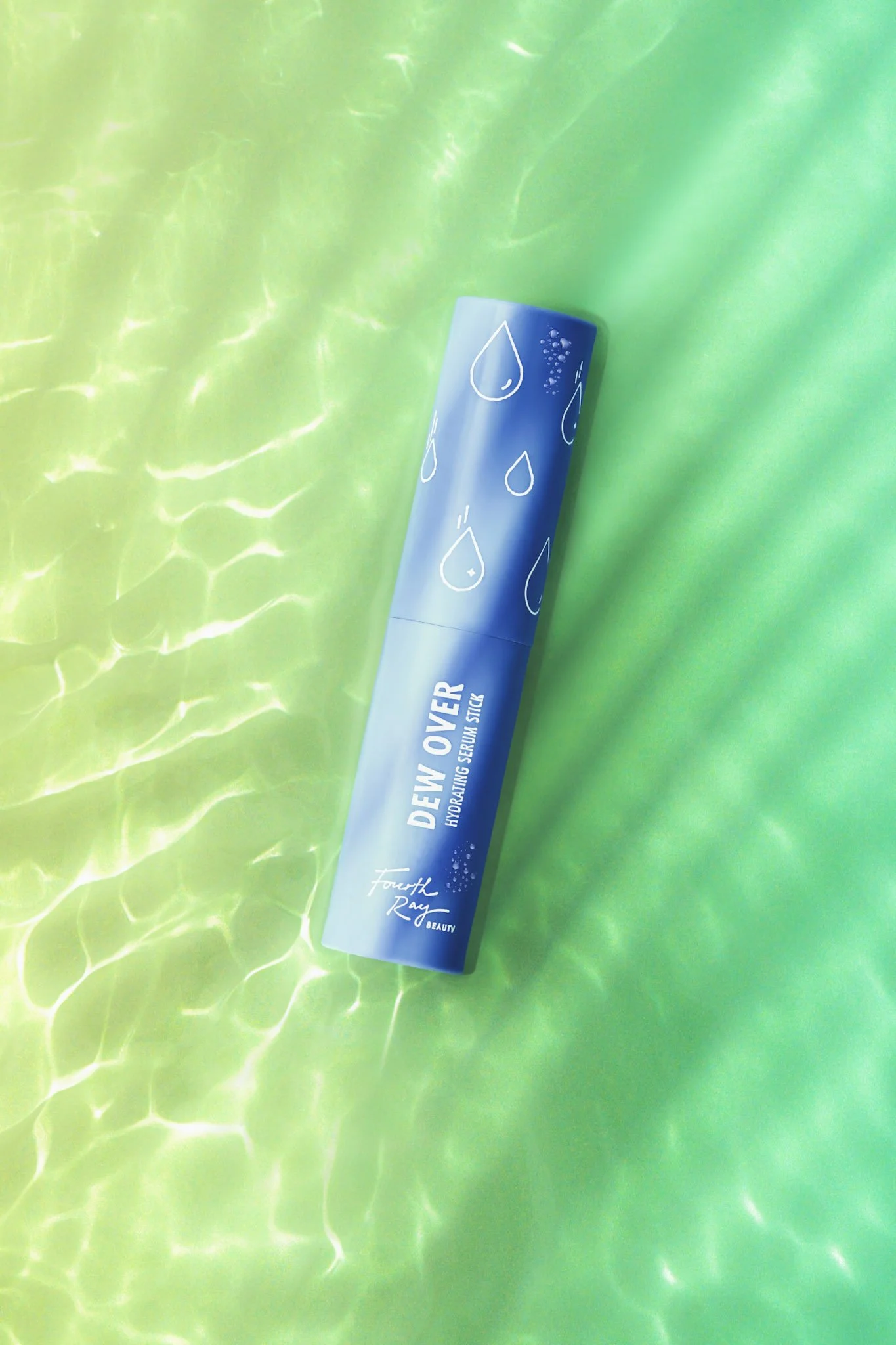 A blue cylindrical tube with a water drop and bubble design lies on a green surface that resembles water, with reflections and ripples.