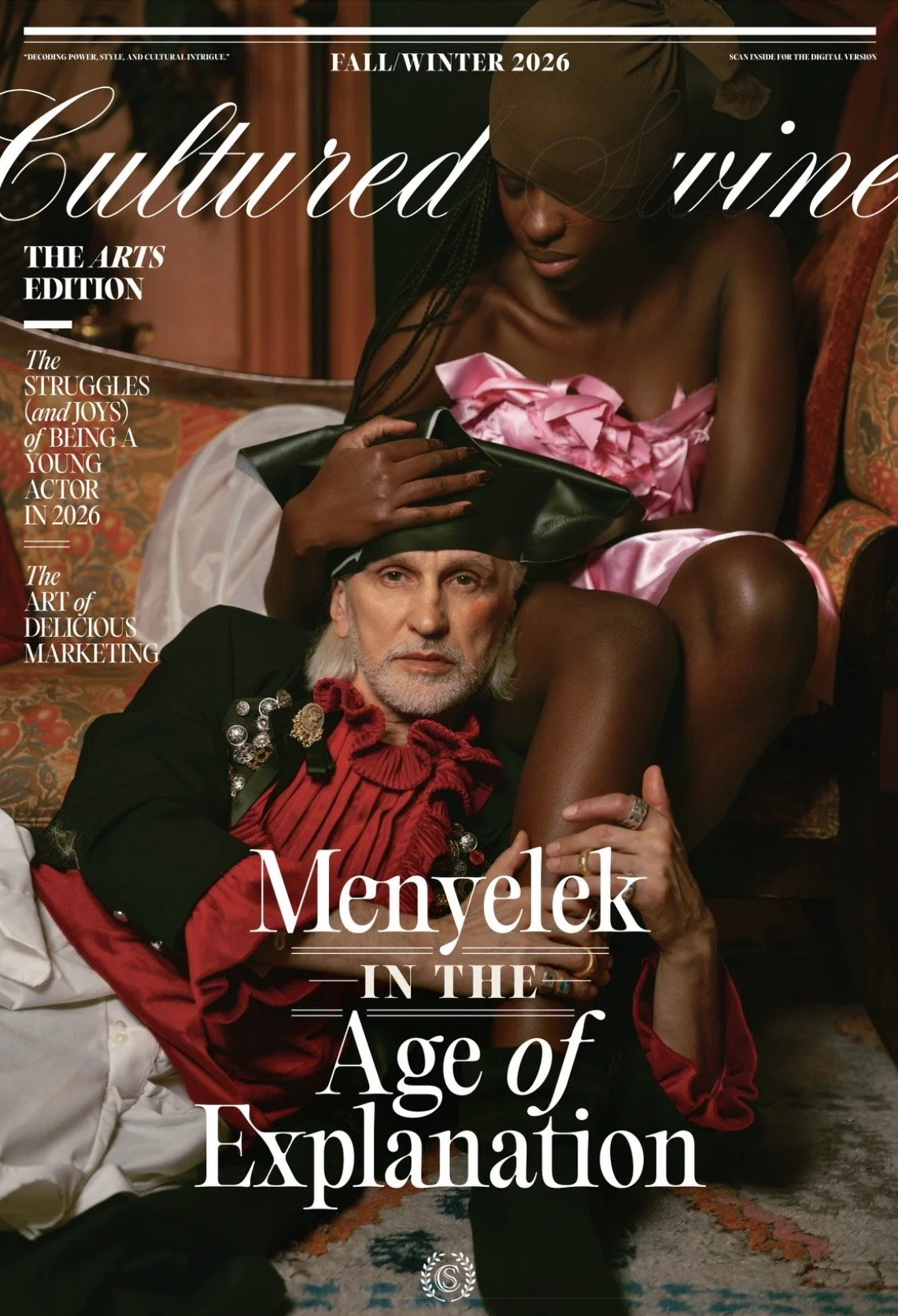 Magazine cover for Cultured magazine, Fall/Winter 2026 edition, featuring a Black woman in pink satin dress with braids, sitting behind a man in a red and black costume, holding his head with her hand. The man has a beard, gray hair, and is wearing a black hat with silver embellishments and a fancy red and black outfit. The cover story is titled "Meylek in the Age of Explanation."