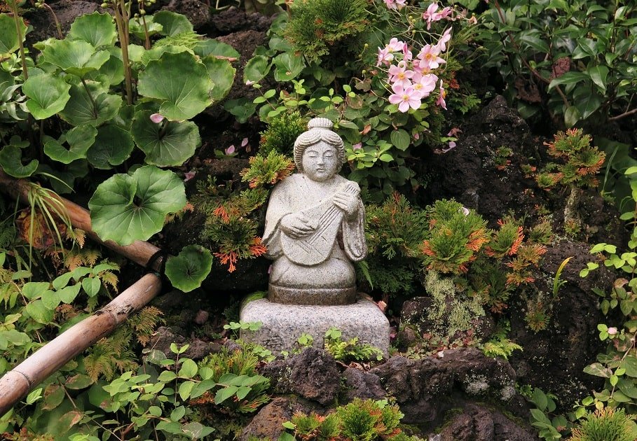 Contemplative stone statue in a garden