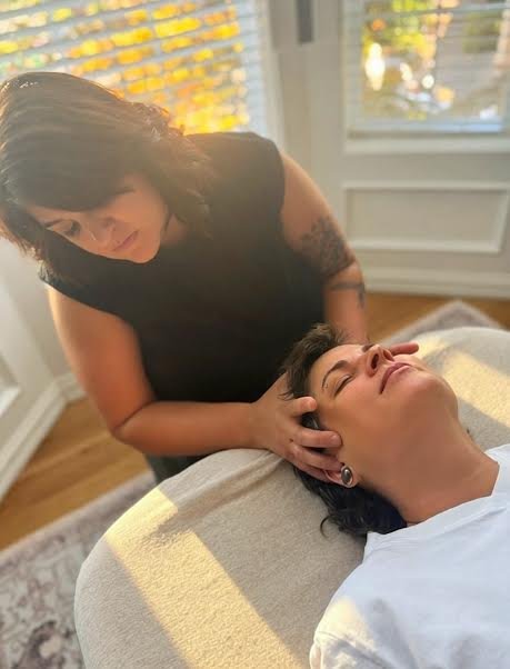 Jinae performing a craniosacral session at Rooted Moon Wellness in North Portland