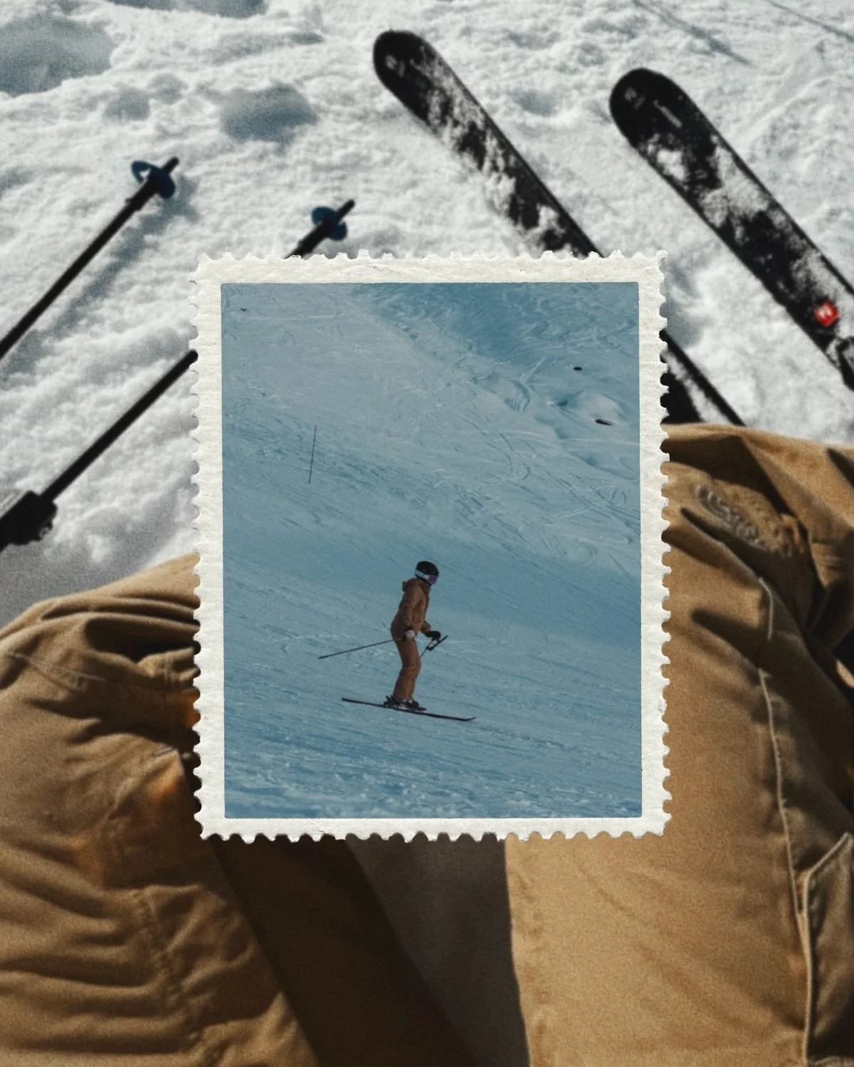 A person skiing on a snow-covered slope, viewed from the skier's perspective, with ski poles and skis visible in the foreground.