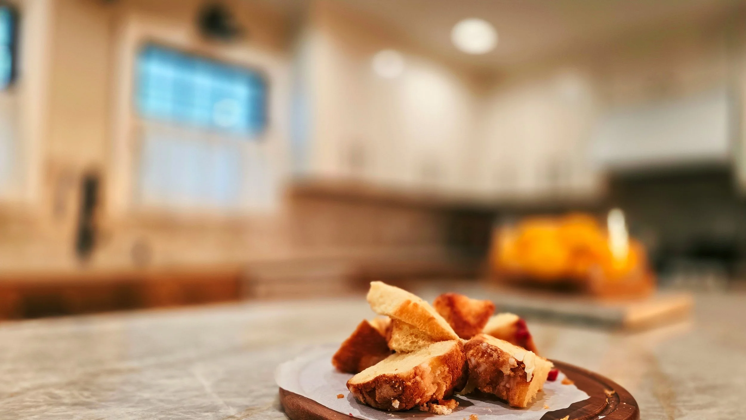 Close-up of sliced pie placed on parchment paper on a wooden tray in a kitchen setting.
