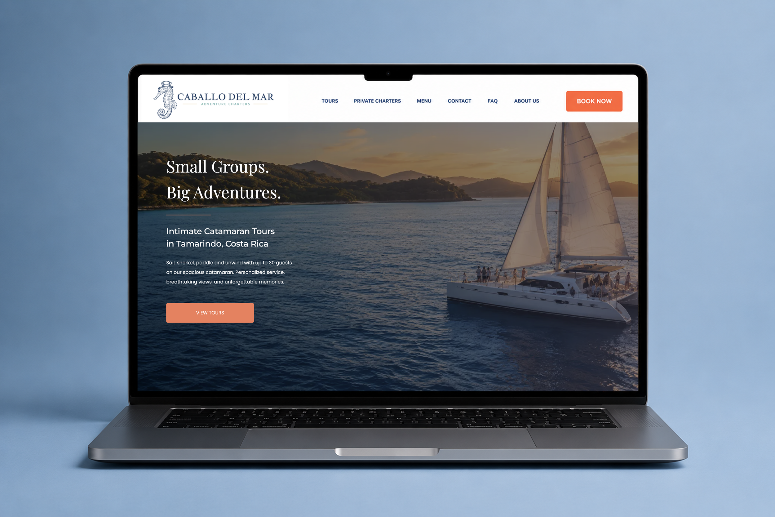 Laptop displaying a website for Caballo Del Mar adventure charters, showing a sailboat on water at sunset with navigation menu and tour information.