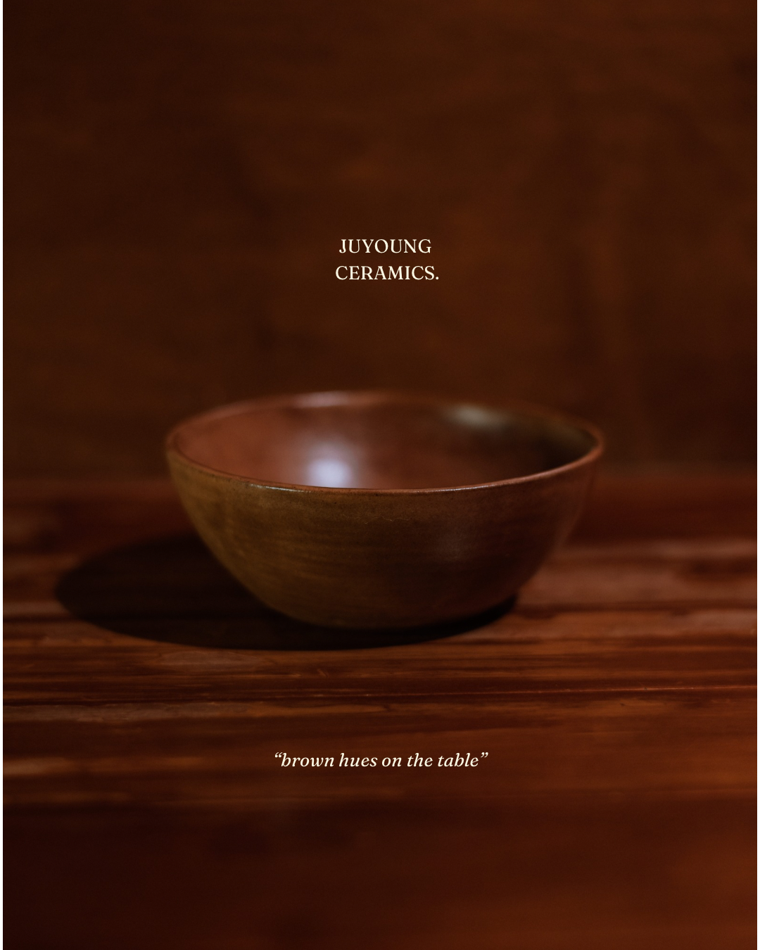 handmade brown ceramic bowl on rustic dark wood table