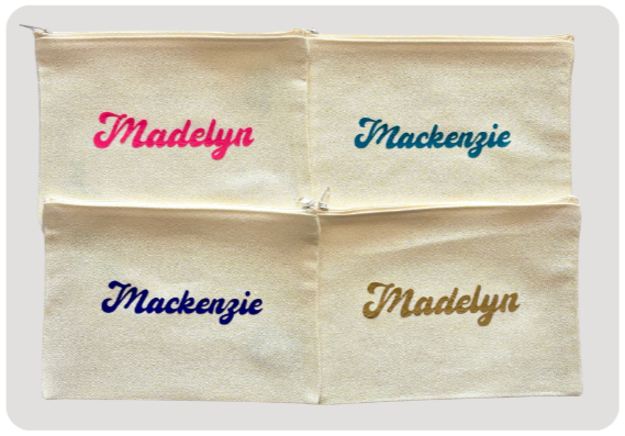Four cream-colored fabric bags with embroidered names: Madelyn in pink, Mackenzie in teal, Mackenzie in navy, and Madelyn in gold.
